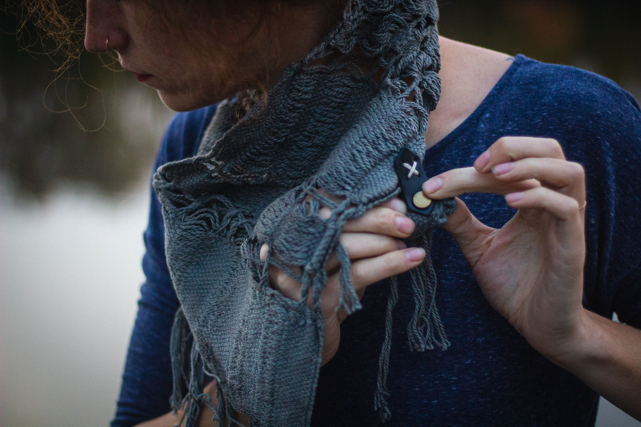 The snap side of the cowl will go under the leather tab side to accomplish this step.