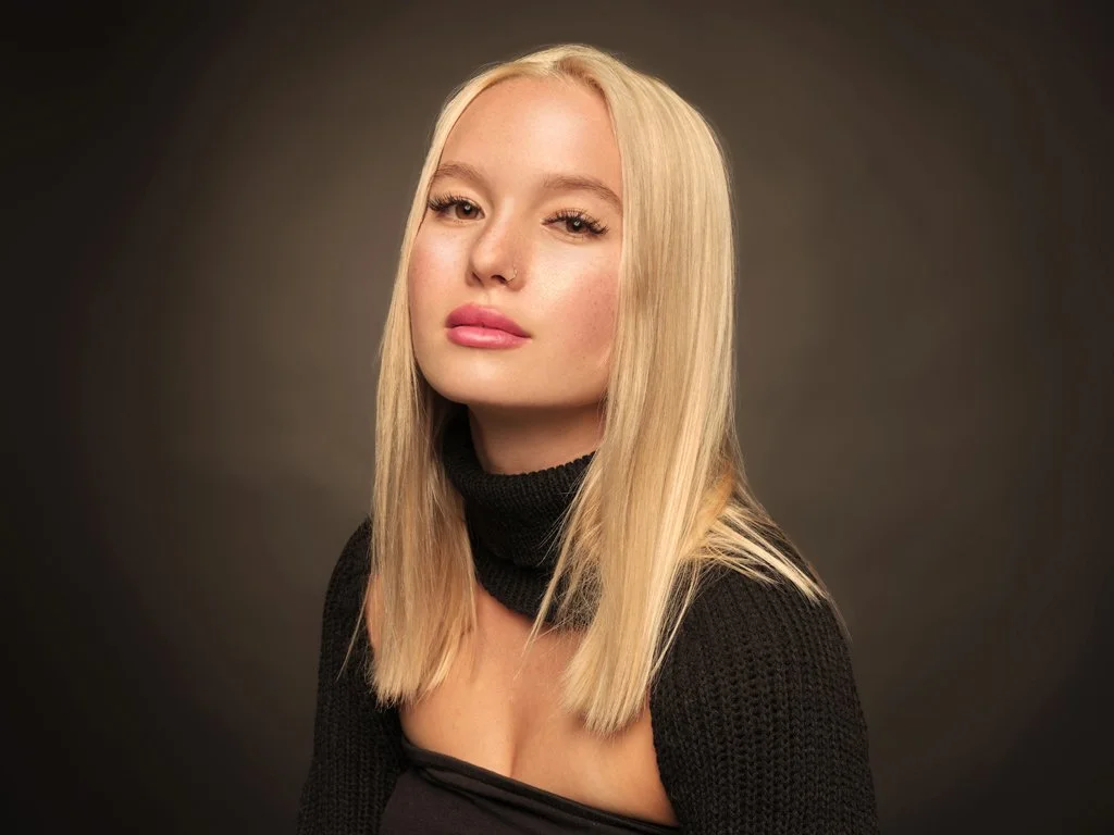 Low-key studio portrait of blonde woman