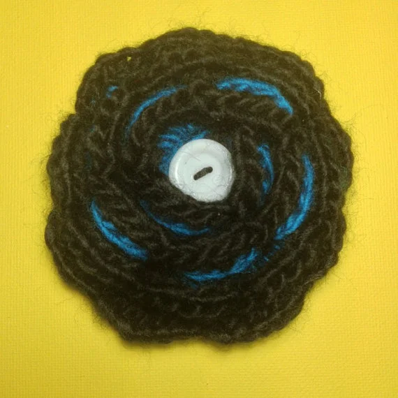 Black & turquoise crochet flower brooch.