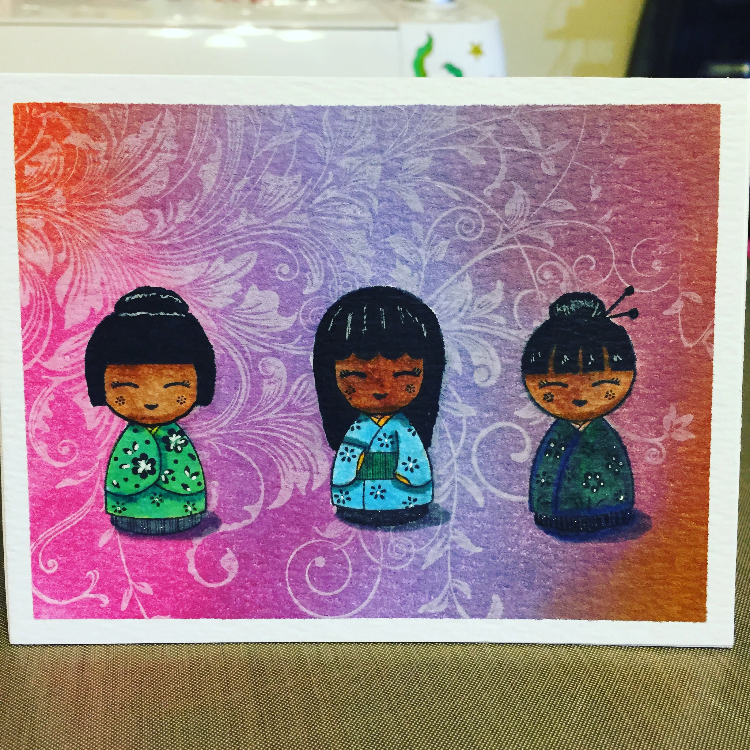Japanese dolls from Hero Arts and a distress ink background.
