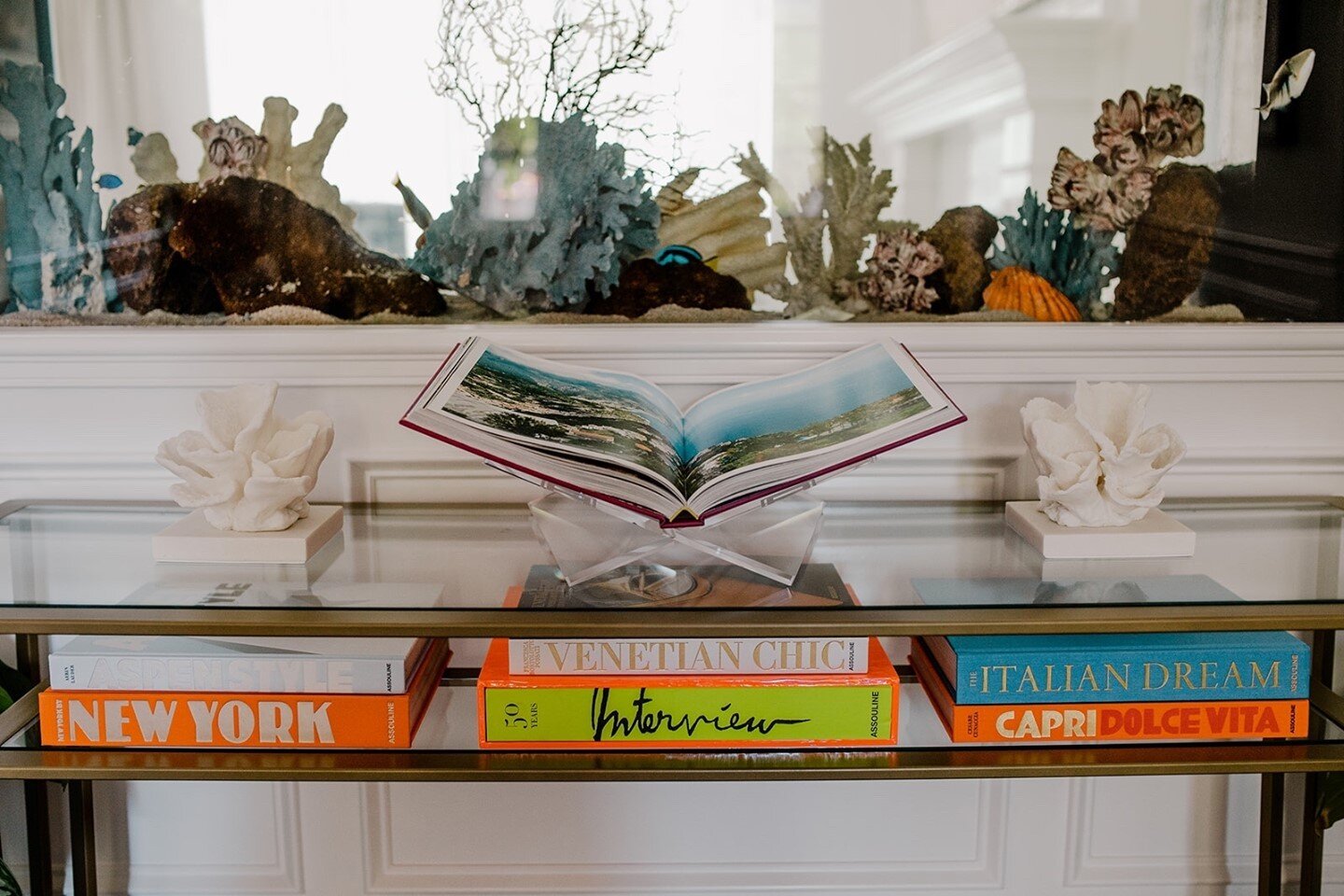 Remember that stunning entryway a few posts back, from our Timeless but Edgy project? We promised you more views, and a playful aquatic element. Now we can share!!⁠
⁠
We&rsquo;re especially into the antique gold console full of art books we placed in
