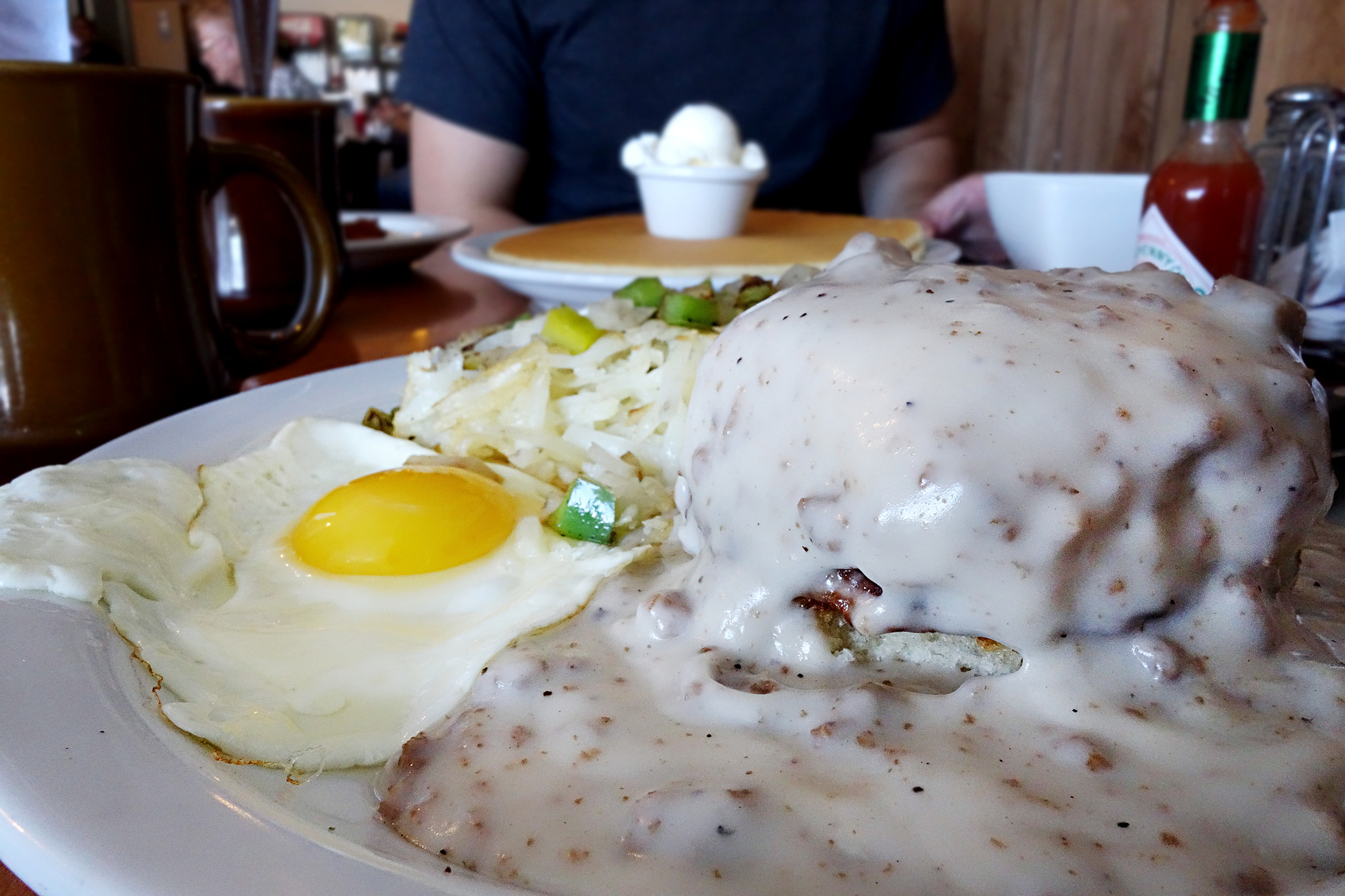 Pop's Country Breakfast: Sausage Biscuit and Sausage Gravy. Served with Irish potatoes and egg.
