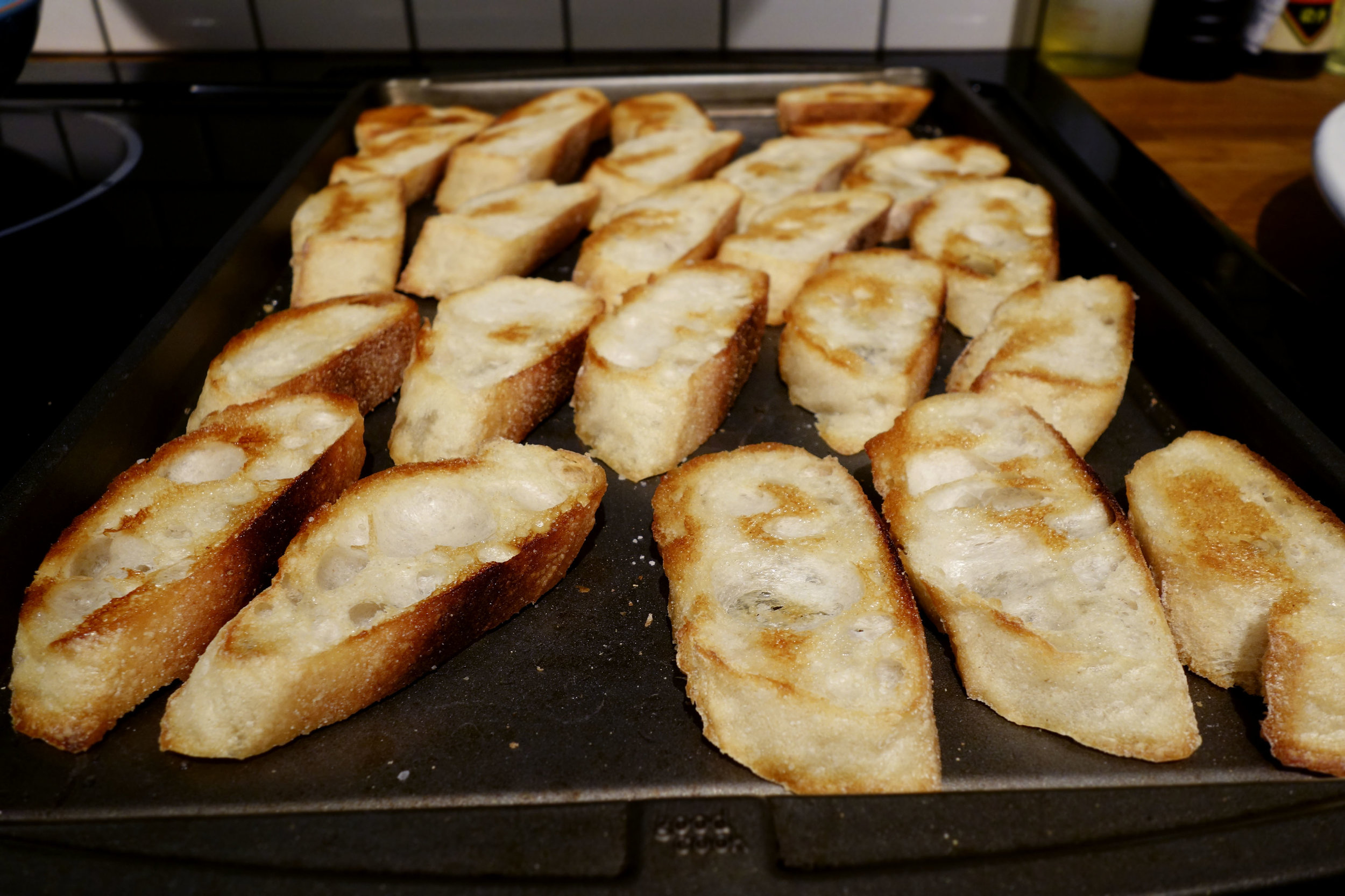 Sliced baguette with olive oil for mussels.