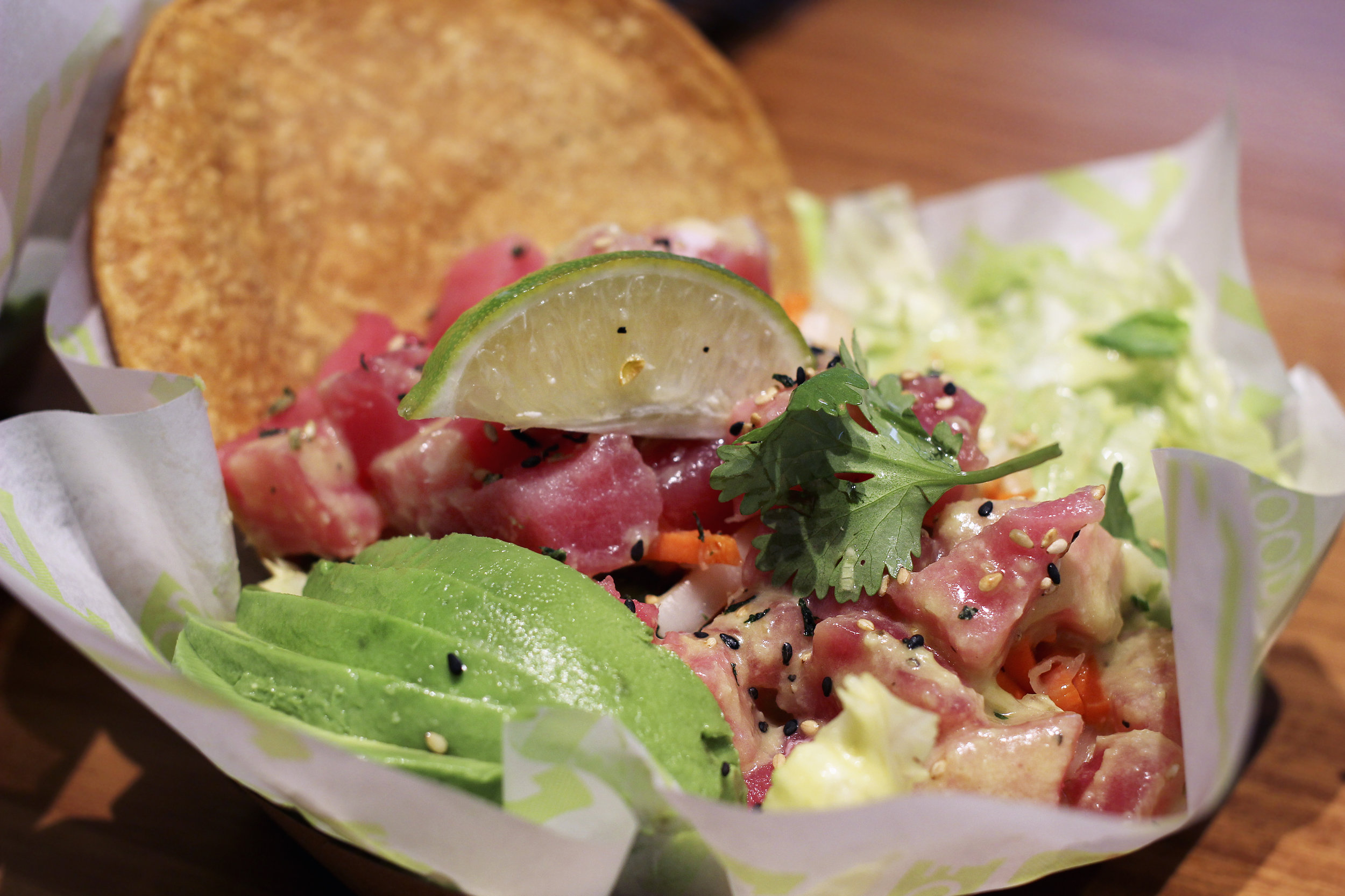 Ahi Tuna Tostada - Tostada with Sushi Grade Ahi, Garlic Ginger Dressing, Pickled Veggies, Avocado, Lime, Cilantro, Iceberg & Sesame Seeds