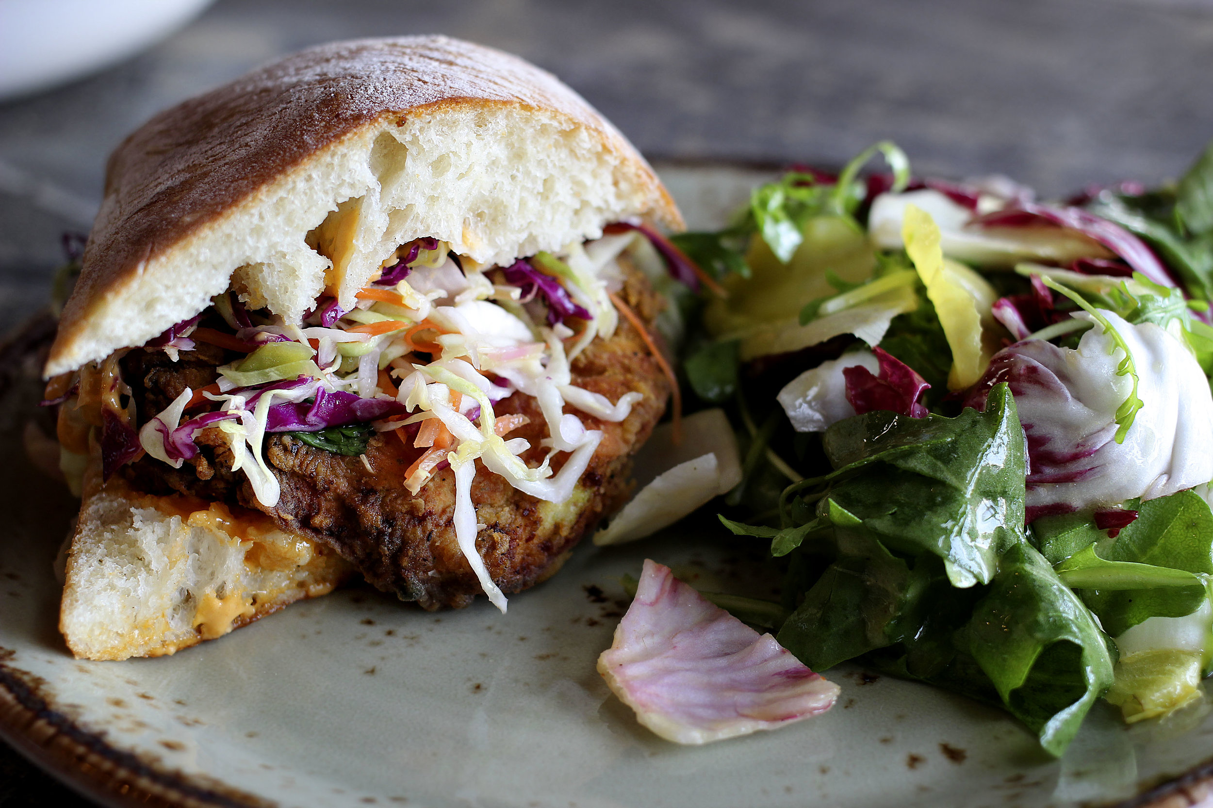 Moroccan Fried Chicken Sandwich - buttermilk, cilantro & jalapeno battered chicken, tangy slaw, harissa aioli on ciabatta