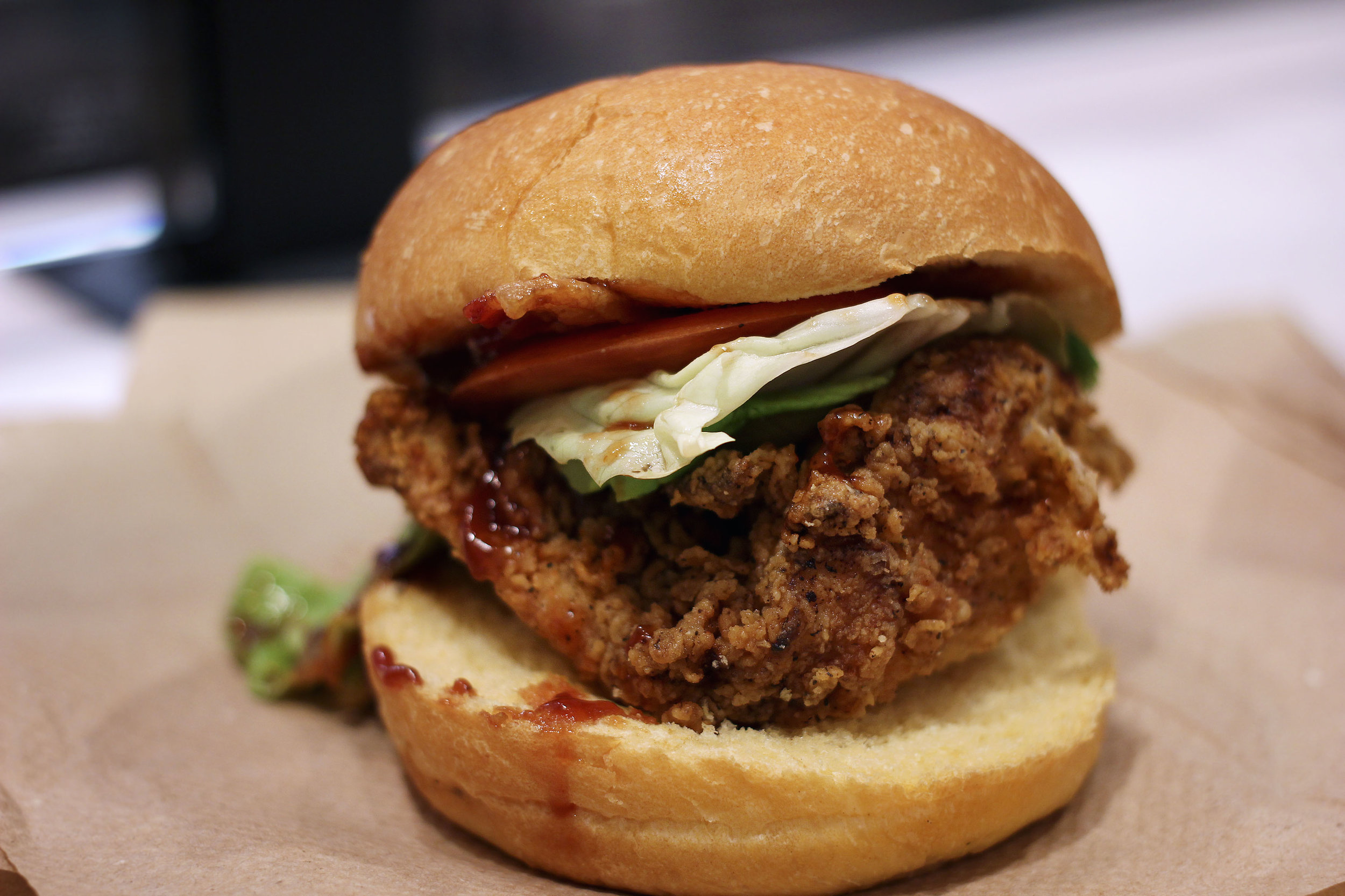 Fried Chicken Sandwich with Bacon, BBQ Sauce, with a potato roll.
