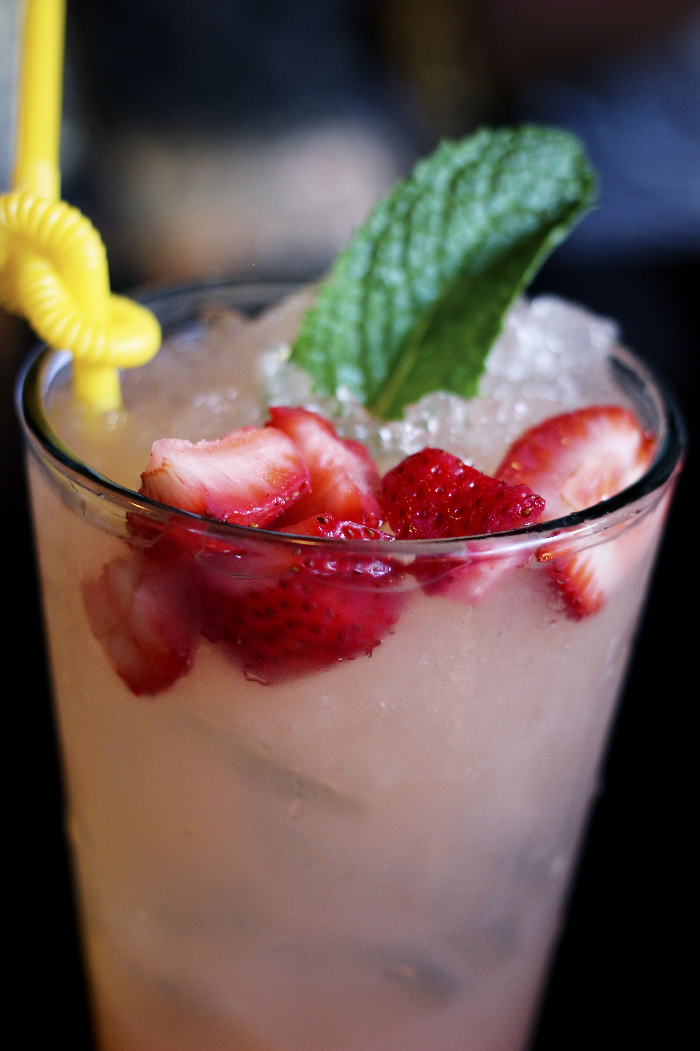 Tall glass of strawberry lemonade. 