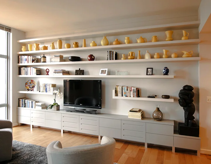 Custom lacquer media cabinetry and floating shelves. We utilize a proprietary system of concealed hardware for a floating shelf system that is rigid, with a high load capacity. Reston, VA