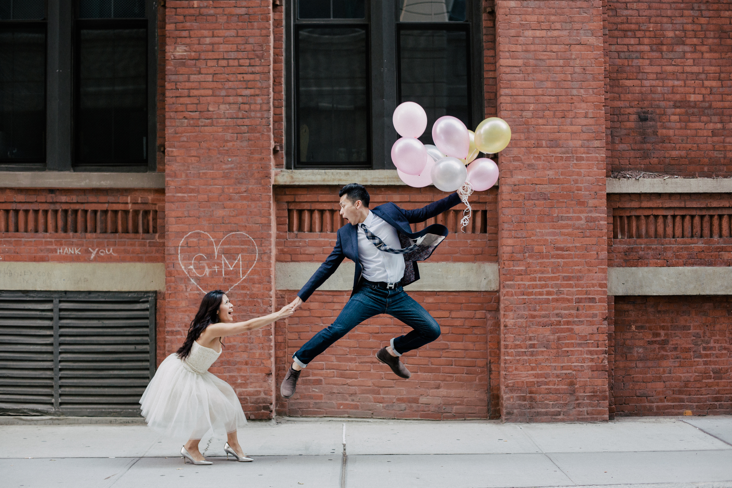 fun jumping engagement photo with balloons