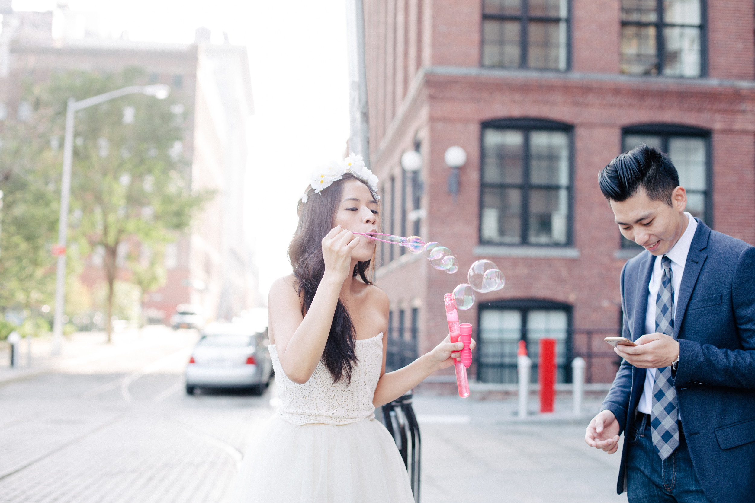 couple blowing bubbles engagement photography