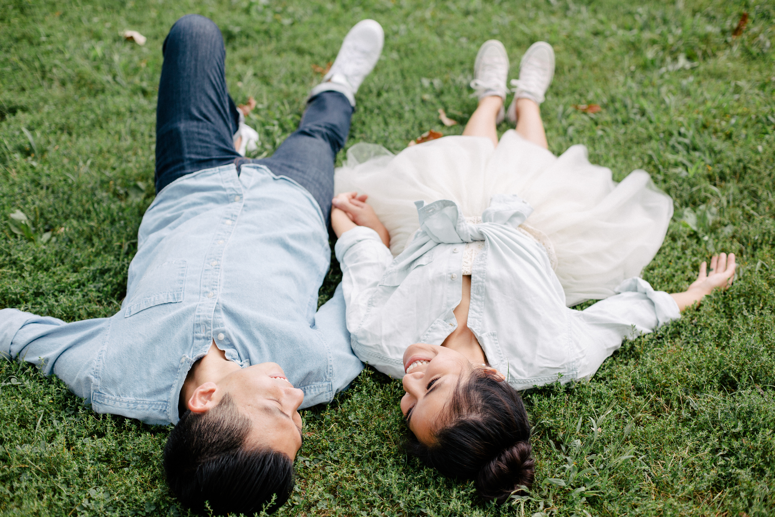 couple laying in the grass engagement session