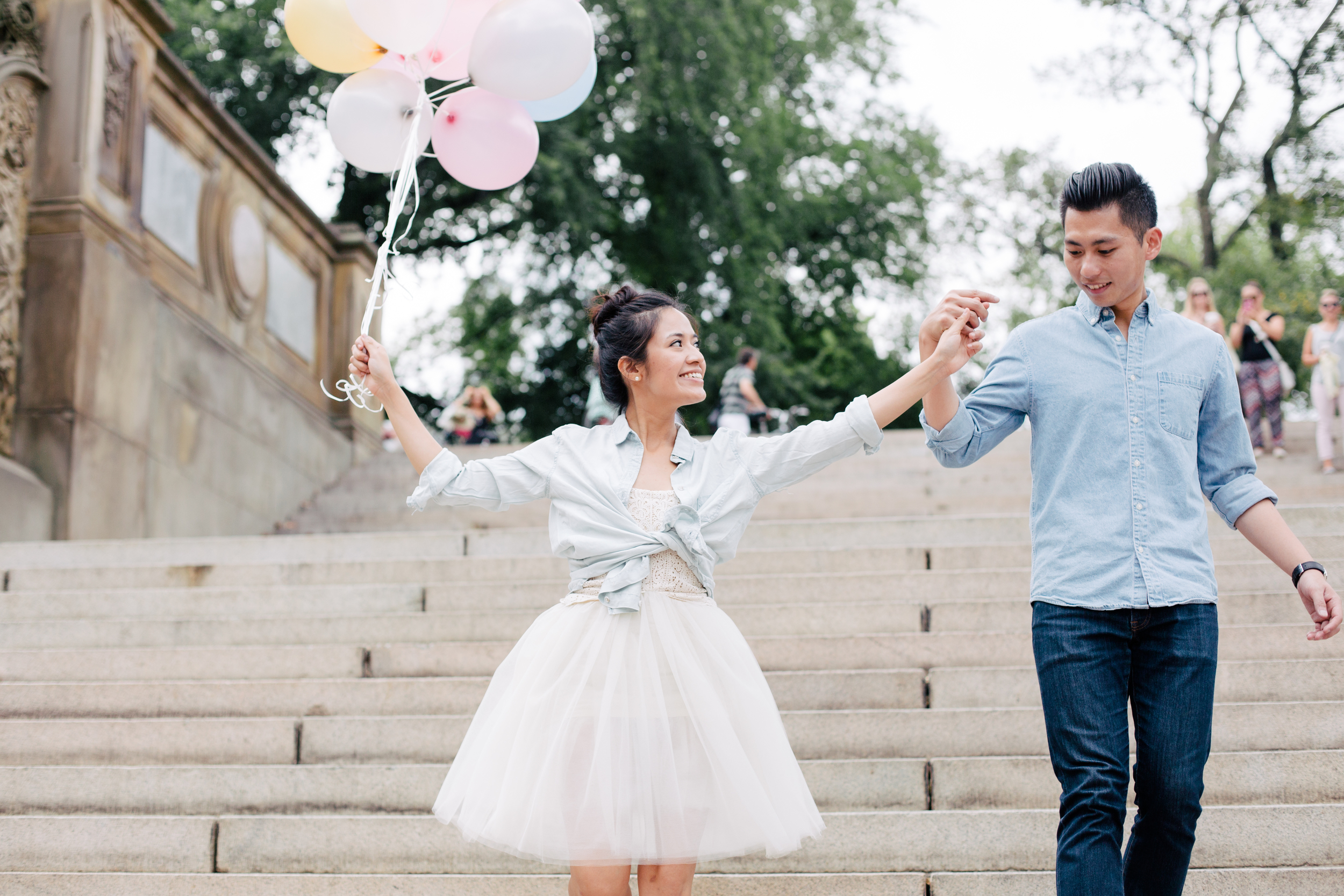 couple walking down stairs in central park engaged