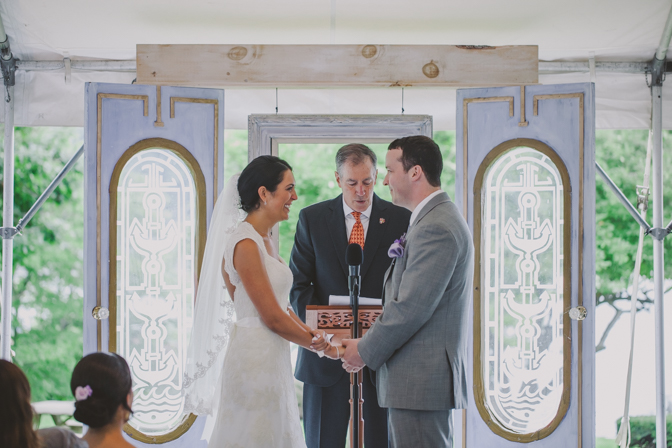 bride and groom holding hands while exchanging vows