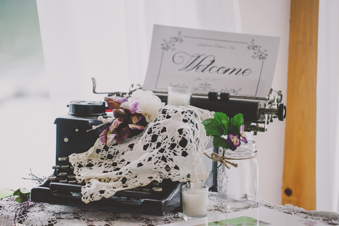 typewriter prop at lakehouse wedding DIY by bridge and groom
