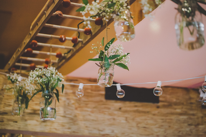 hanging flowers in mason jars as wedding decor