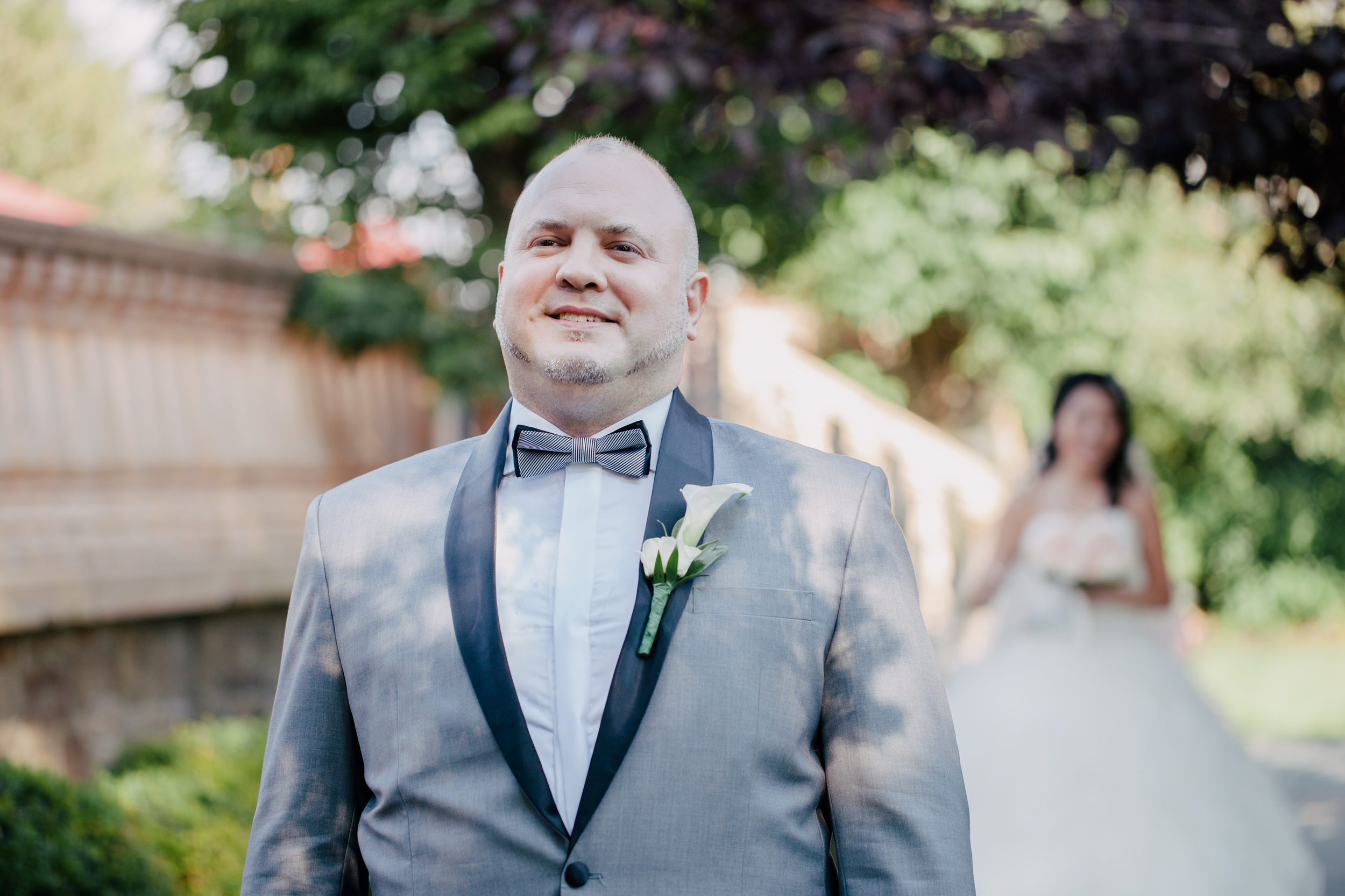 groom waiting to see his bride for their first look