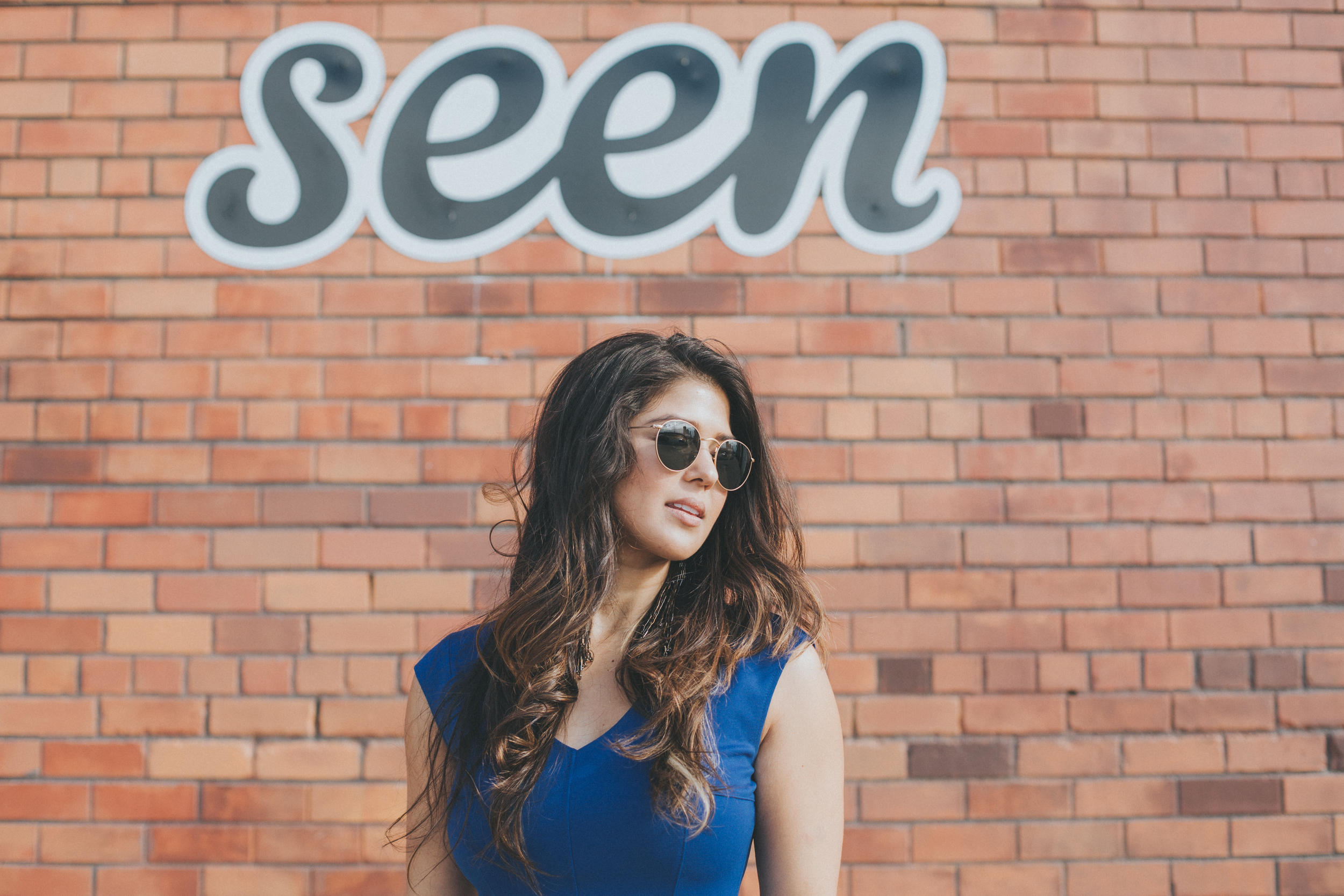 model in front of brick wall in brooklyn