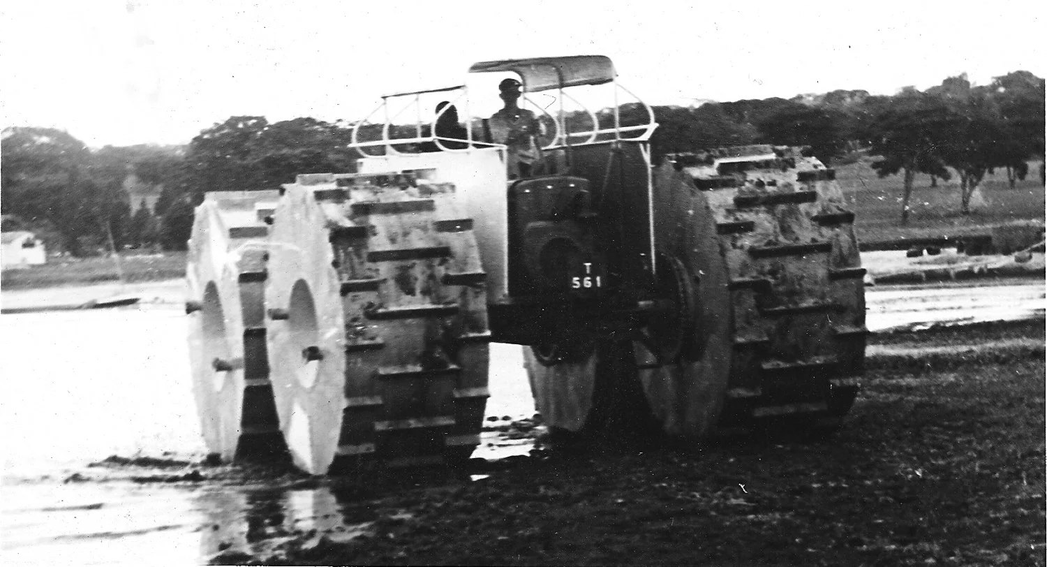 The IRLCS Swamp Skipper coming ashore at Lake Chila, Abercorn after trials. It was powered by two Land Rover engines and was designed and built in the IRLCS workshops by Peter Parton and others in the 1950s. The large floaing wheels were designed to enable the vehicle to operate in the swamps, shallows and grass lands of the Rukwa.