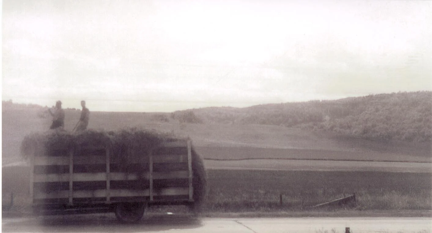A truck moves hay down West Main St (Rt. 2) towards the barn. This photo was taken before imminent domain bisected the farm for the development of Interstate 89.