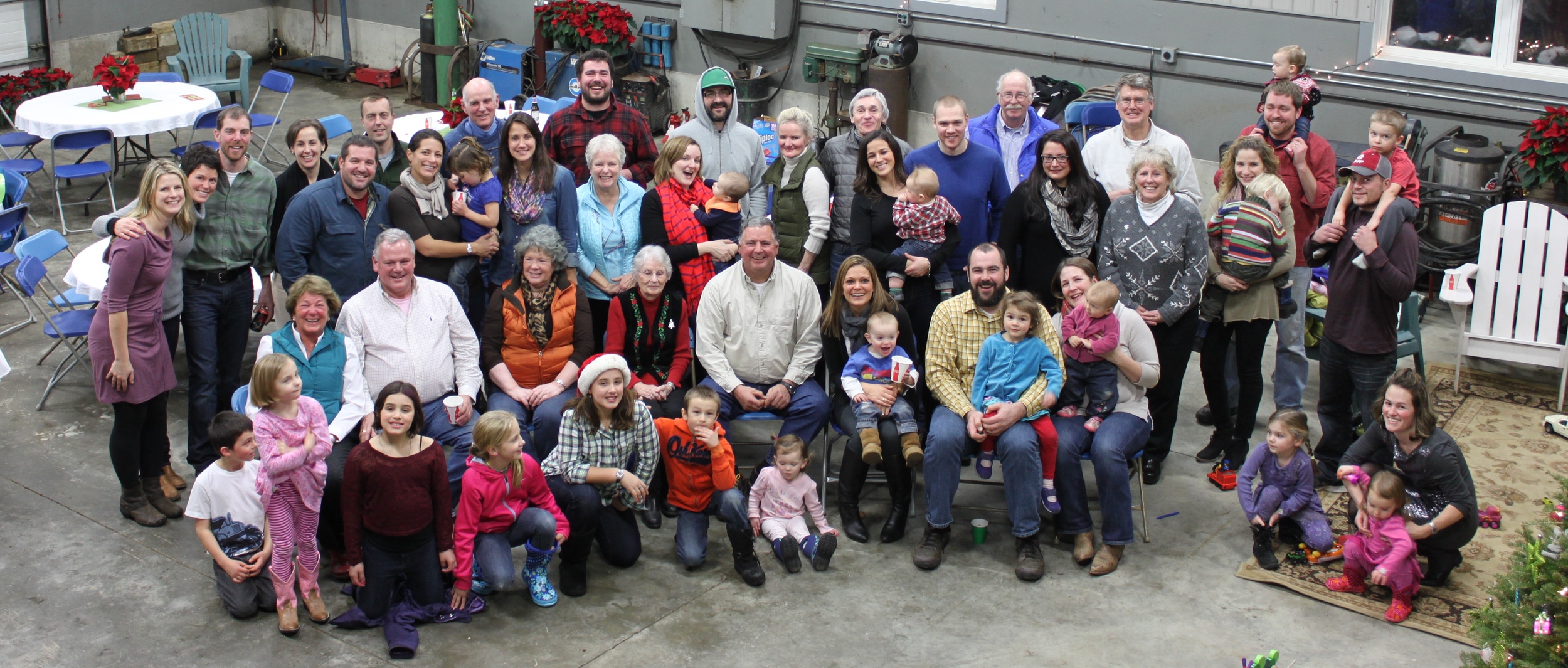 Friends and family celebrating the holidays in the only space still big enough to fit everyone - the machine shop!