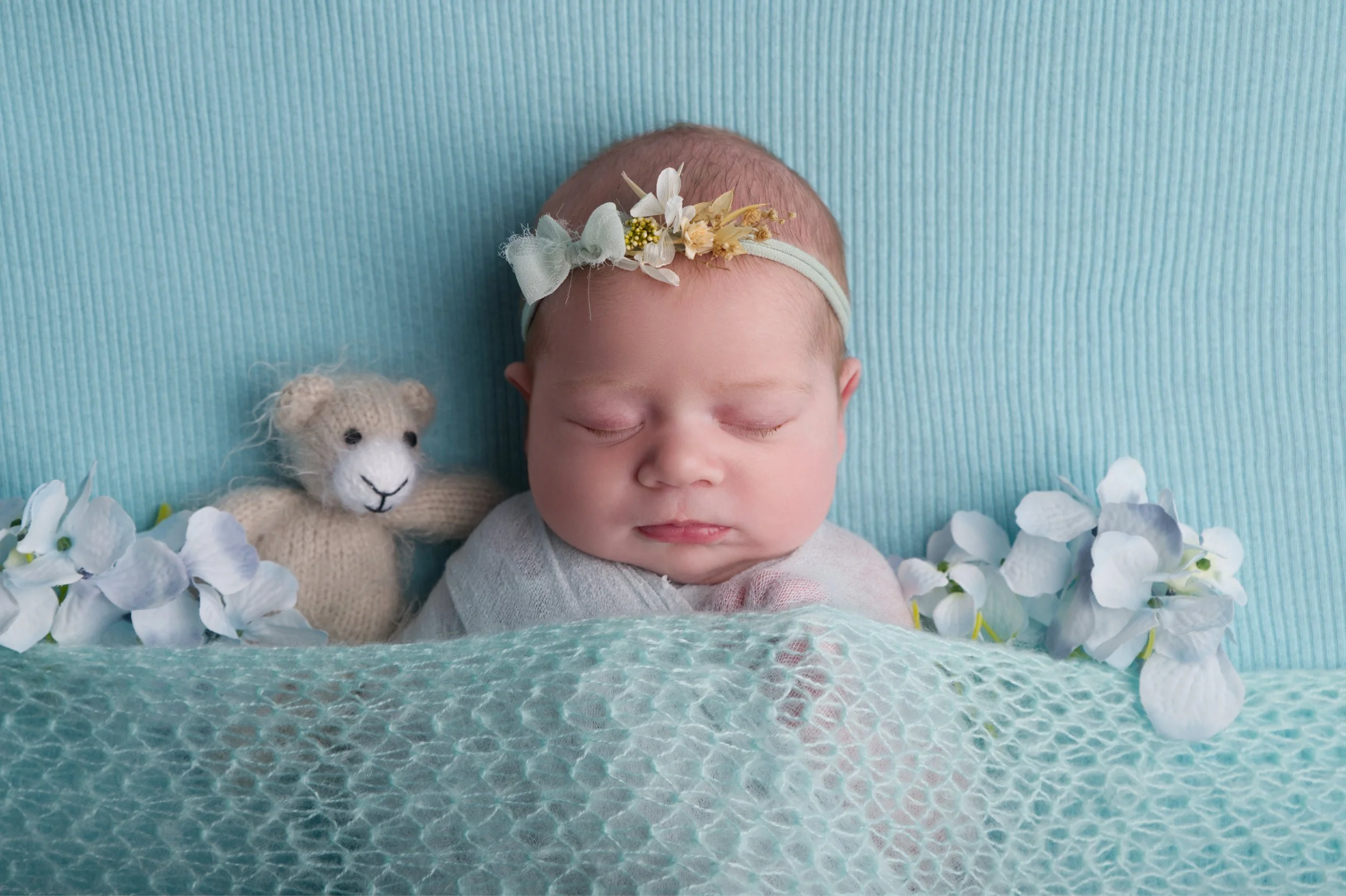 Baby girl on mint blanket