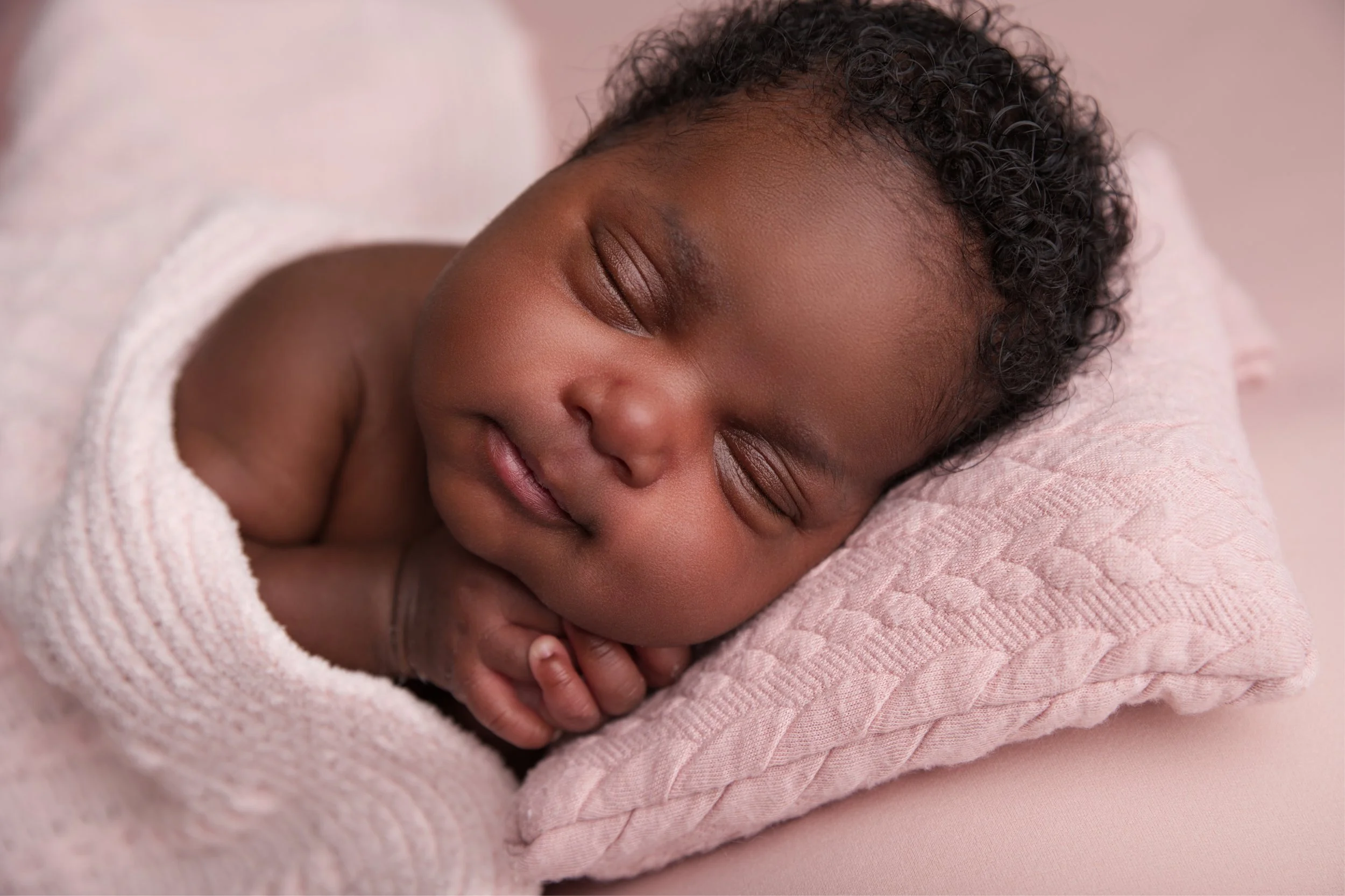Baby girl on pink pillow