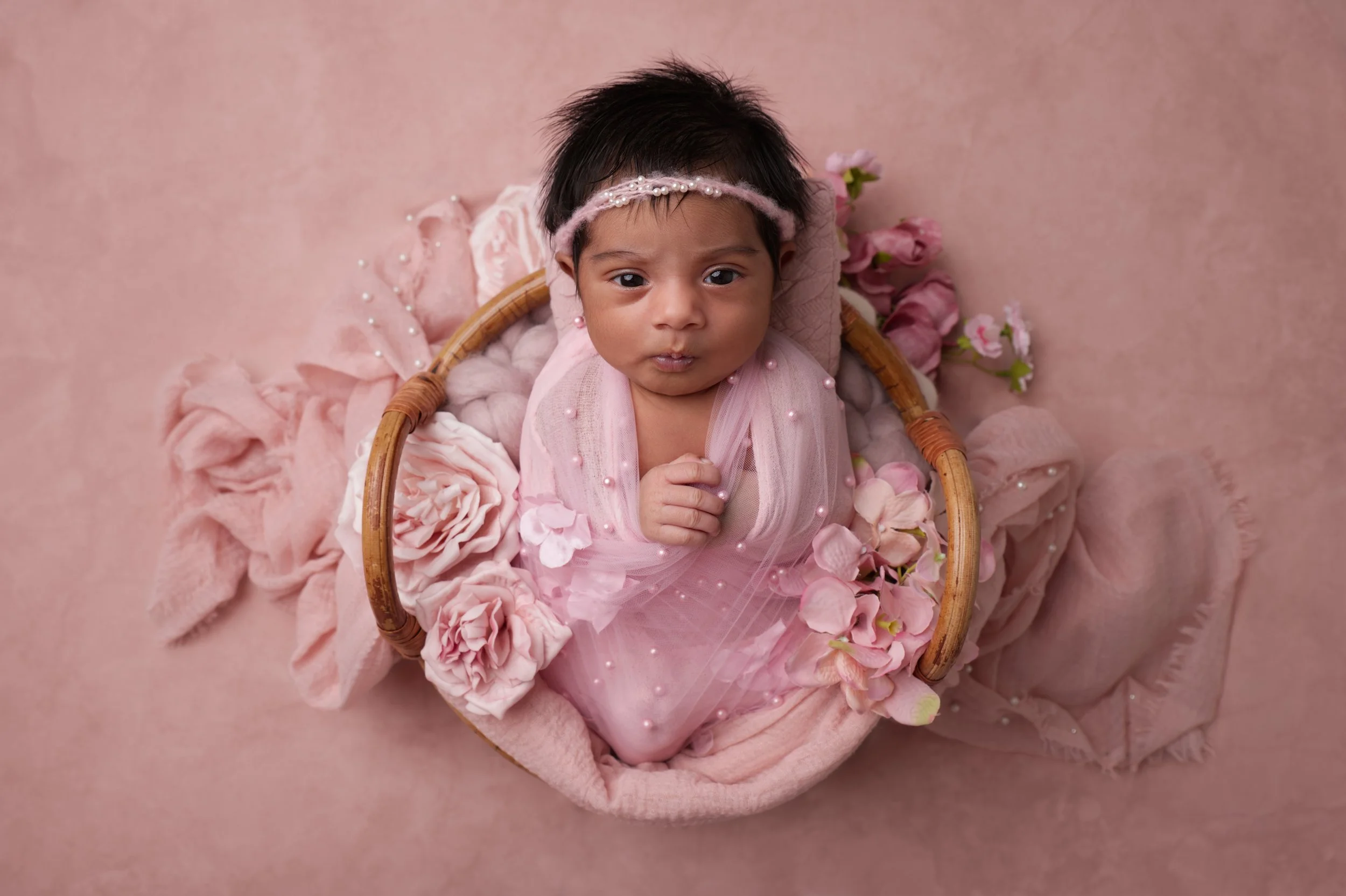 Baby in pink basket