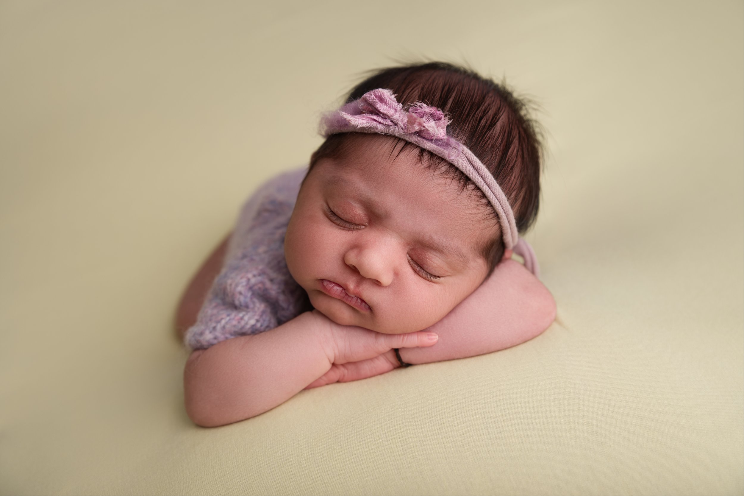 Baby girl on yellow blanket