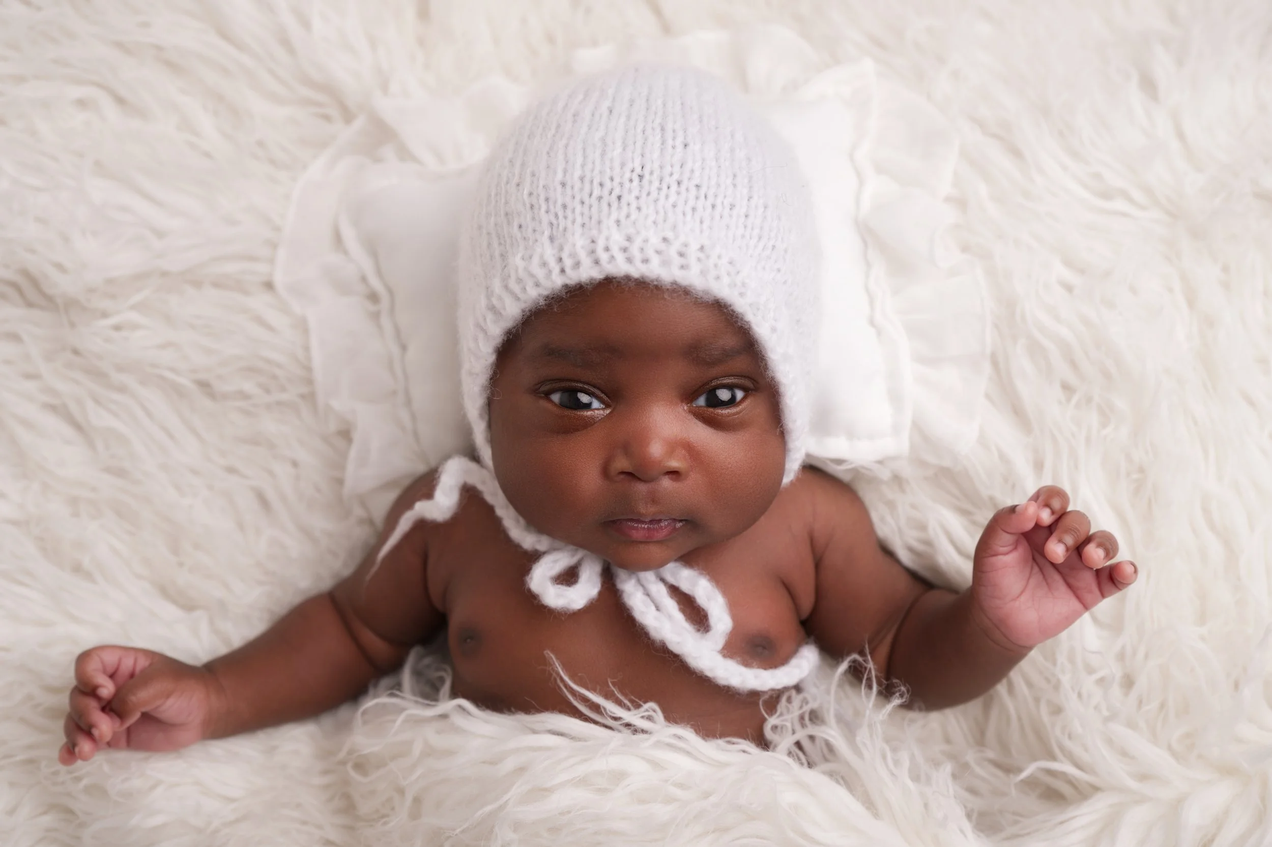 Baby girl in white hat.