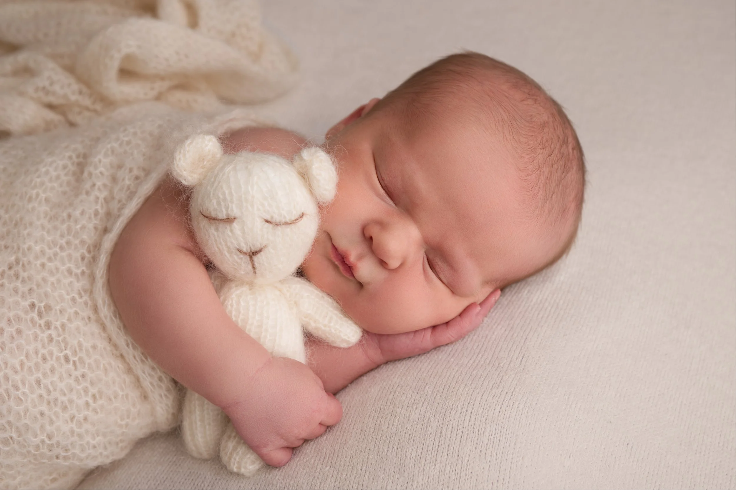 Baby with cream teddy