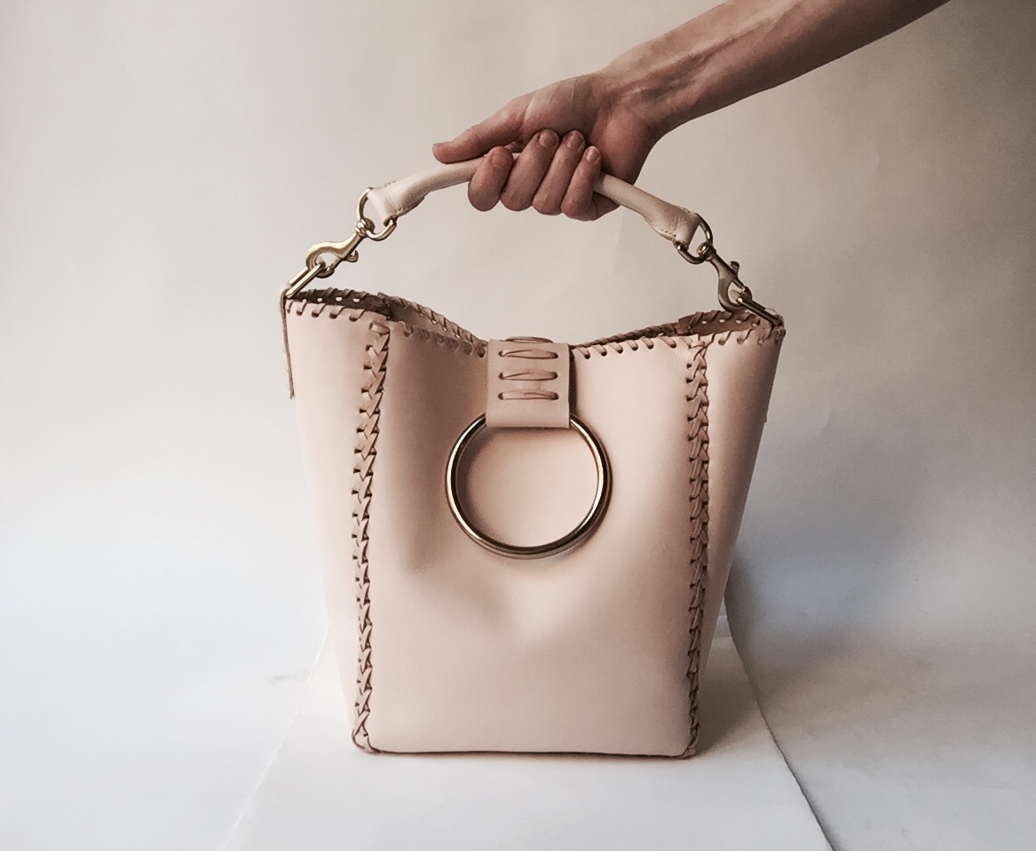 Mary-savel-knocker-tote-nude-hand-on-handle.jpeg