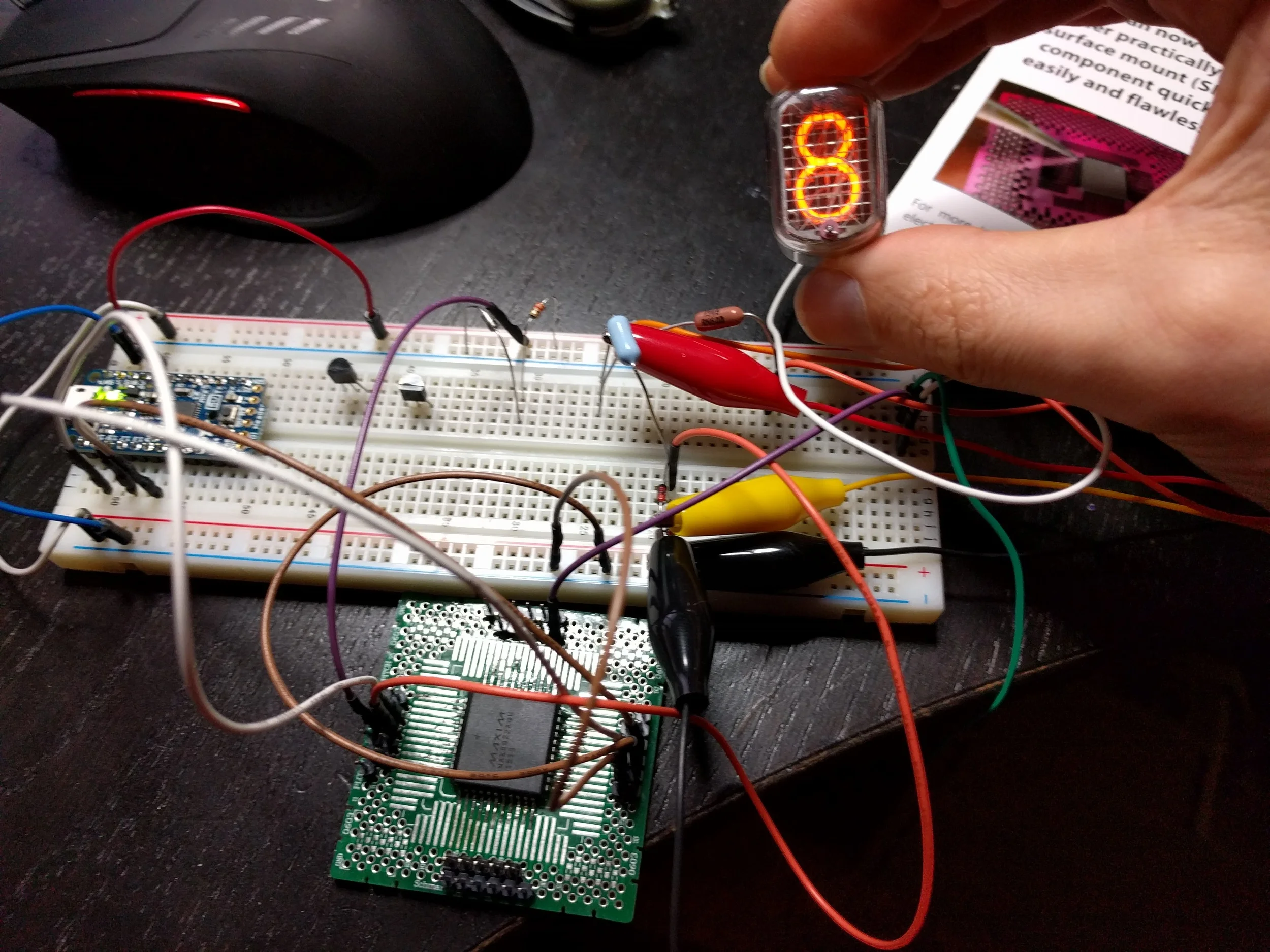 It's alive! Pro Trinket on left, transistors "stored" on the breadboard, MAX6922 on SchmartBoard PLCC adapter.