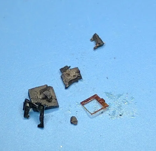 The remains after removing the die. The square metal piece is not the metalization ring mentioned below, but rather was surrounding the die.