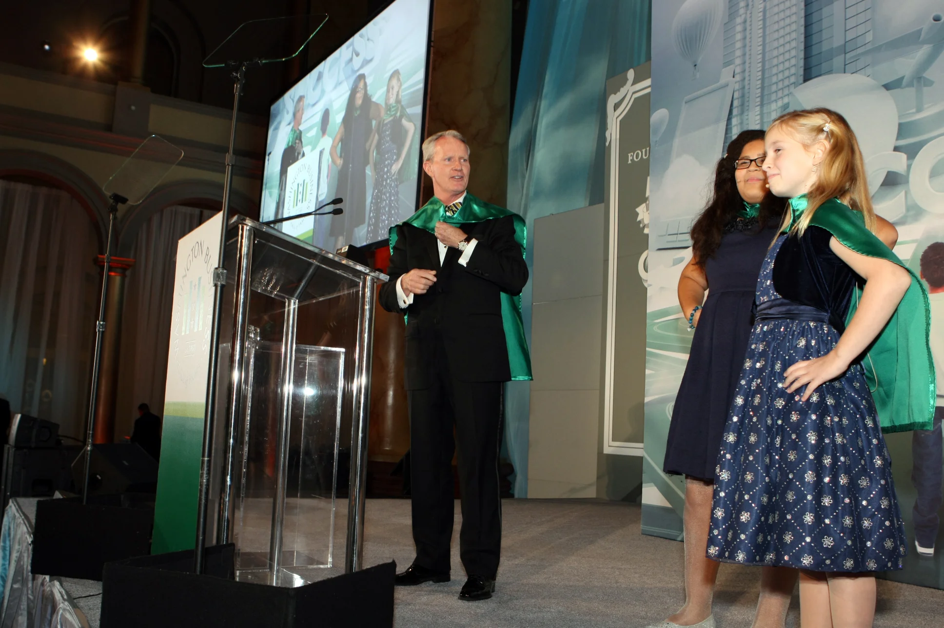 2015 Event Chair Jerry Carlson with JA superheroes Kennedy Cawley (left) and Vivian Poe (right)