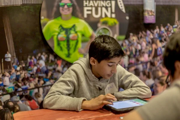 A student works through the financial literacy curriculum, learning about how arts and entertainment fits into his budget.