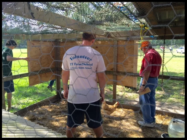 Gerry Curts directs the rebuilding of the chicken coop with help from Dylan.