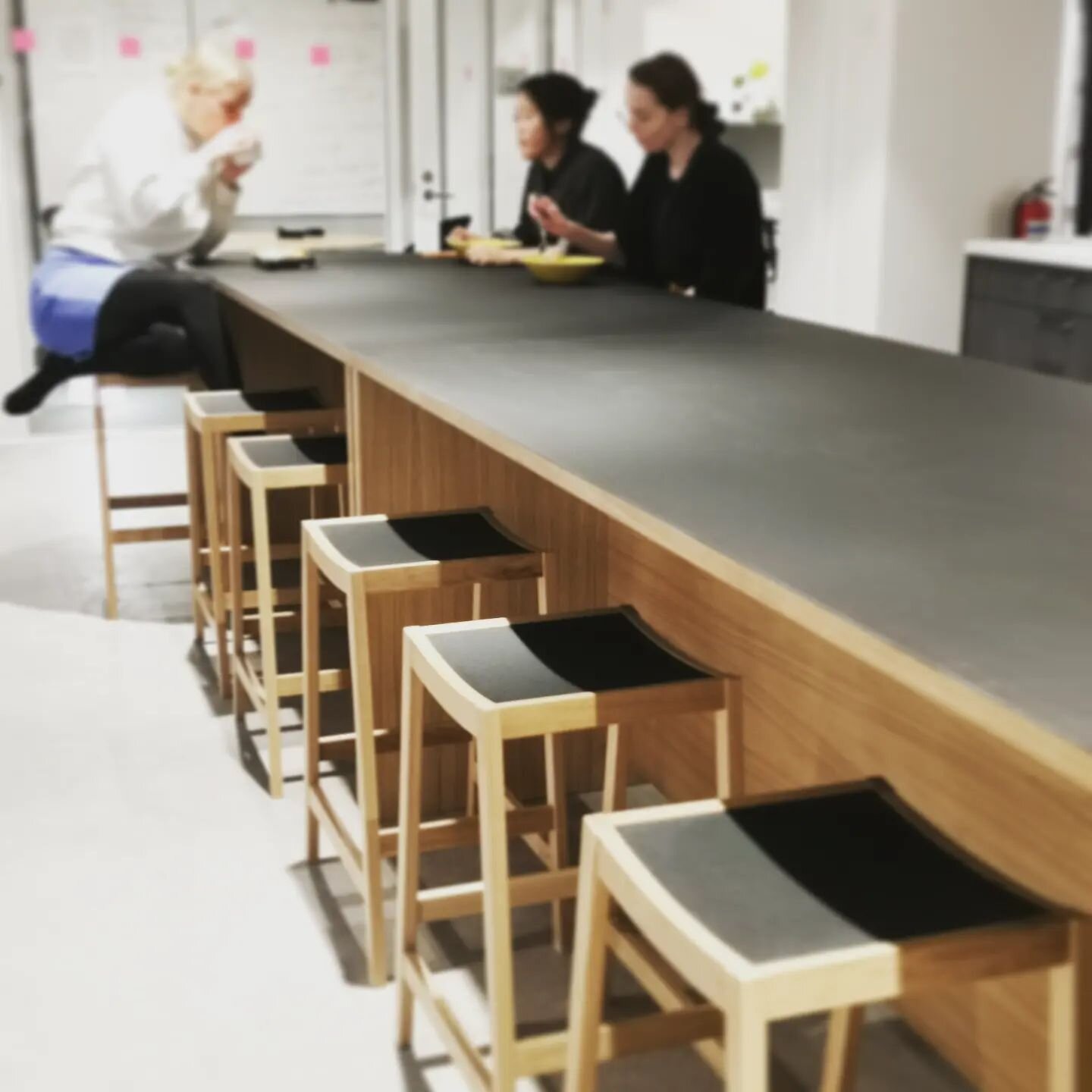 Two big tables together with 12 Baja  barstools.
Just seconds after getting the furnitures on place they where already in full use.

Tables with black linoleum top and oak veneer bases.
Baja in massiv oak and linoleum seat, design @benfredriksson
Big
