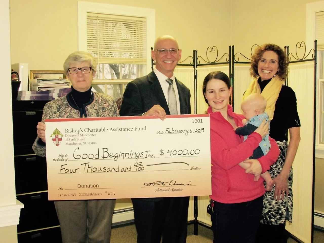 Pictured left to right are: Cathy Girard (Good Beginnings’ volunteer) Dr. Joseph Pepe (Bishop’s Association board and CEO at Catholic Medical Center and GraniteOne Health) Alexis (Good Beginnings’ volunteer and recipient of our services) and baby son Karen Morton (Good Beginnings’ Executive Director)