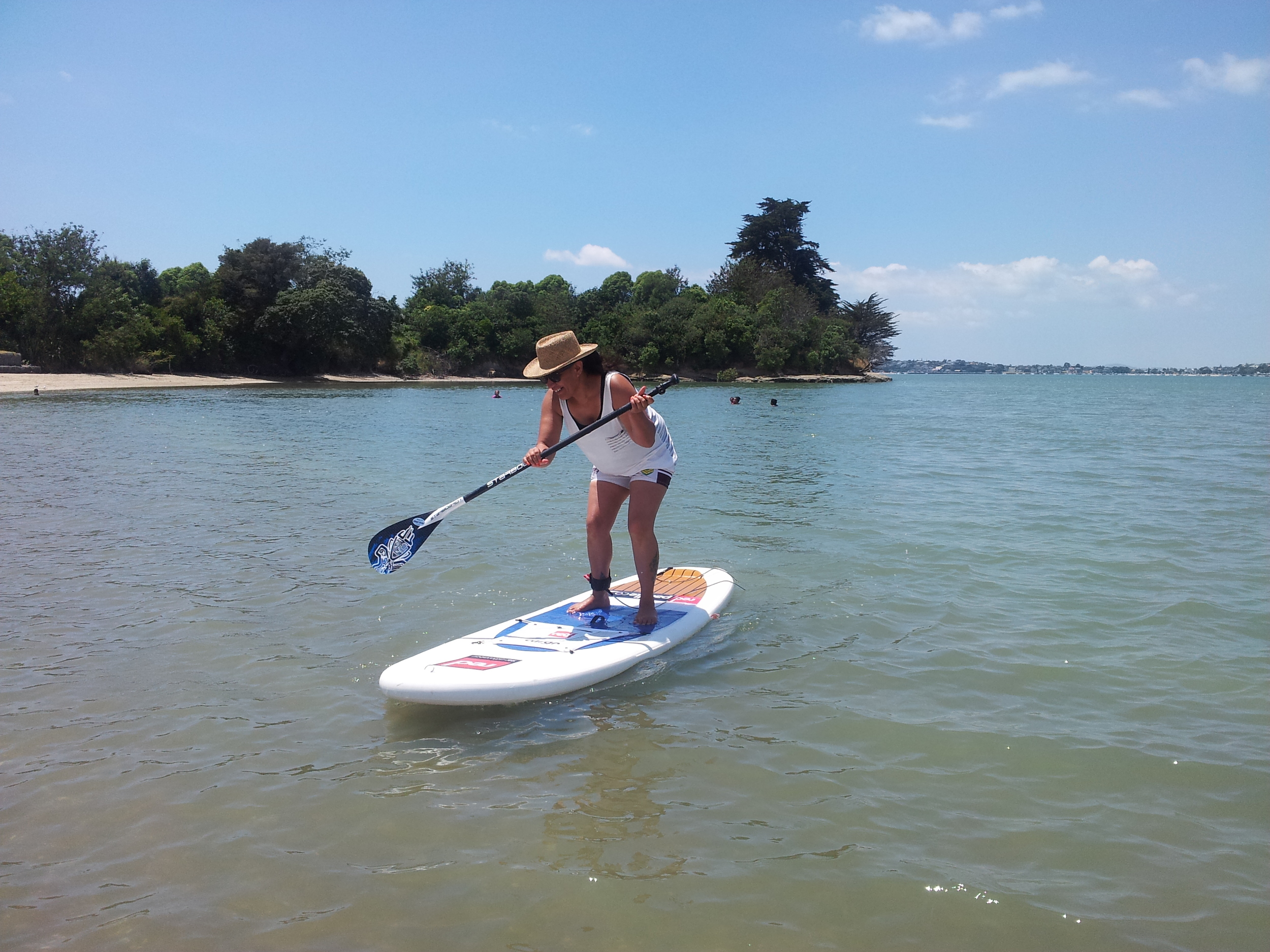WRAP member Naomi enjoys paddle boarding at Point England beach at the WRAP picnic over summer.