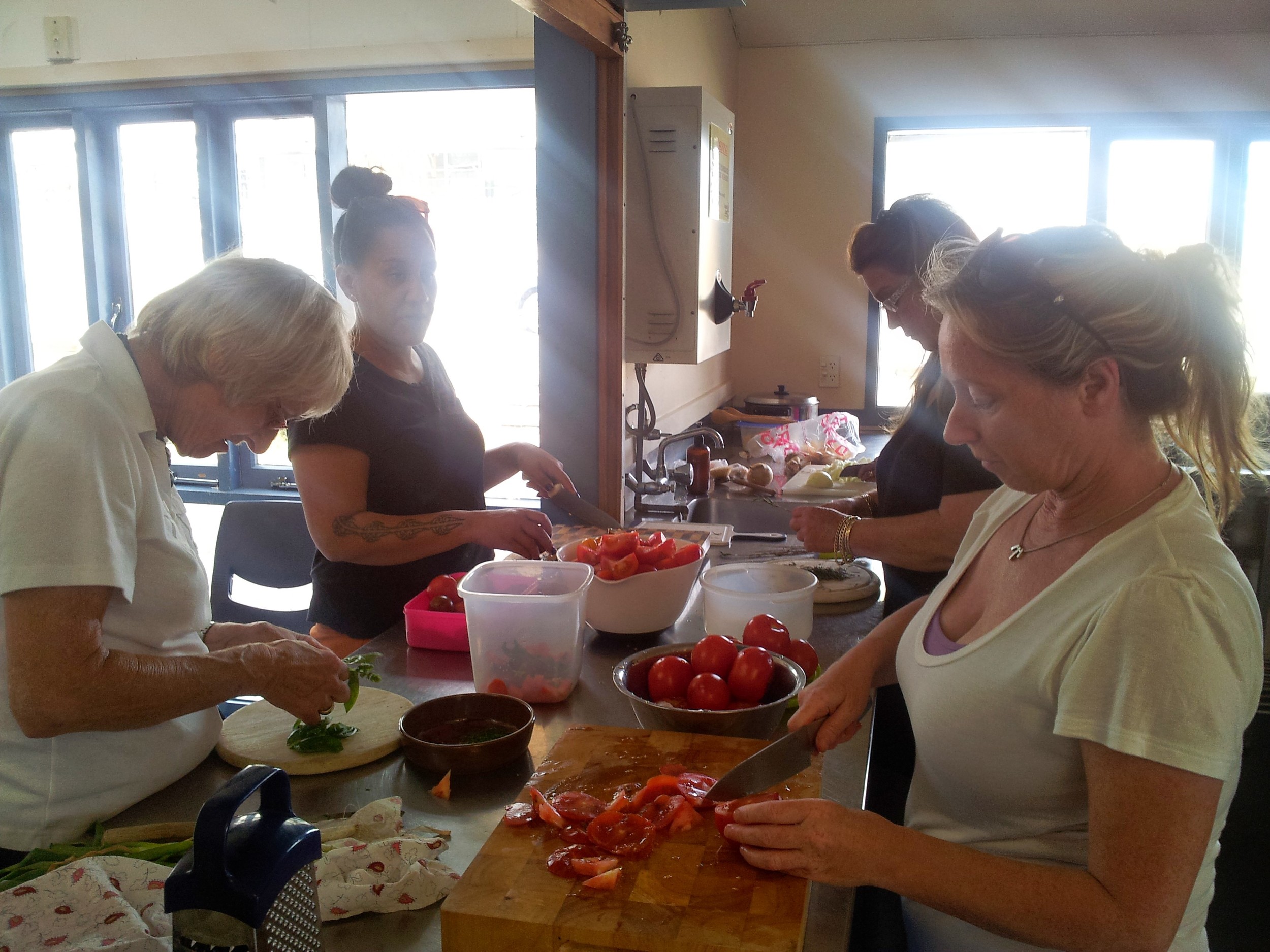  'Preserving the Summer Harvest' workshop. Chopping up fresh, local tomatoes, herbs, onions and garlic while sharing knowledge. 