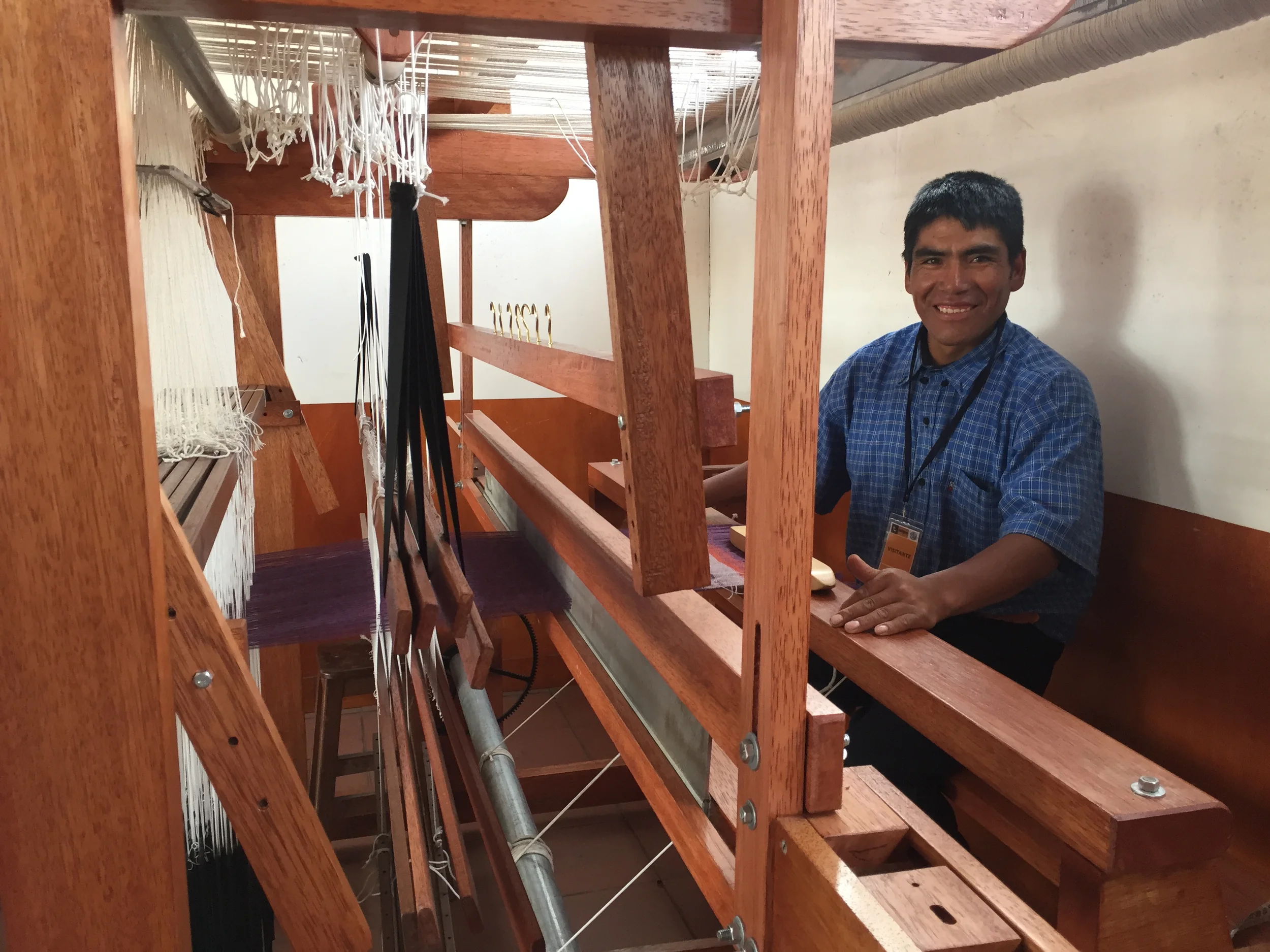 A worker at ALLPA creating a beautiful, woven rug. 