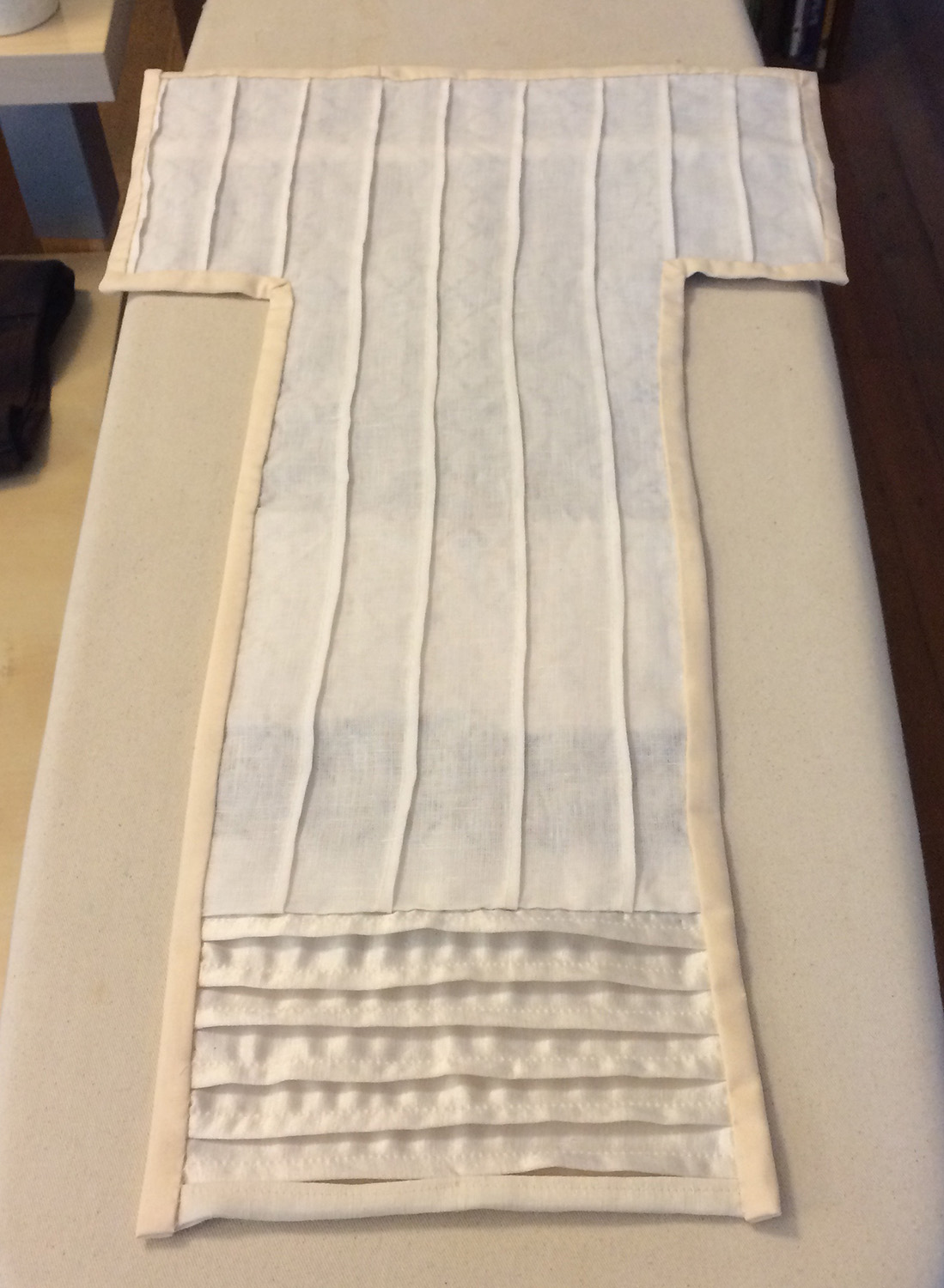 The back of a black and white composition of pleats and quilted squares. 