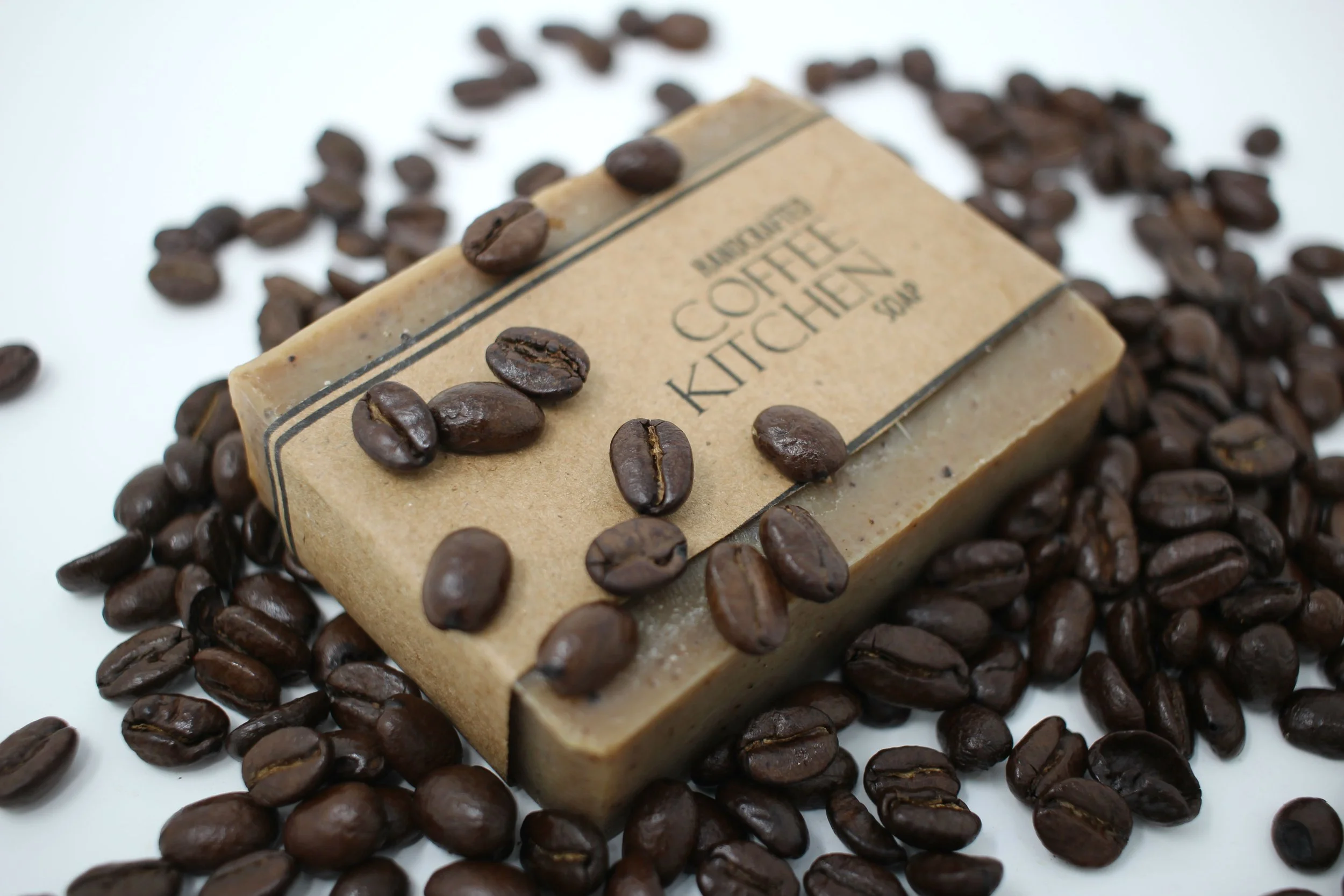 Artisan Coffee Soap bar surrounded by Coffee Beans