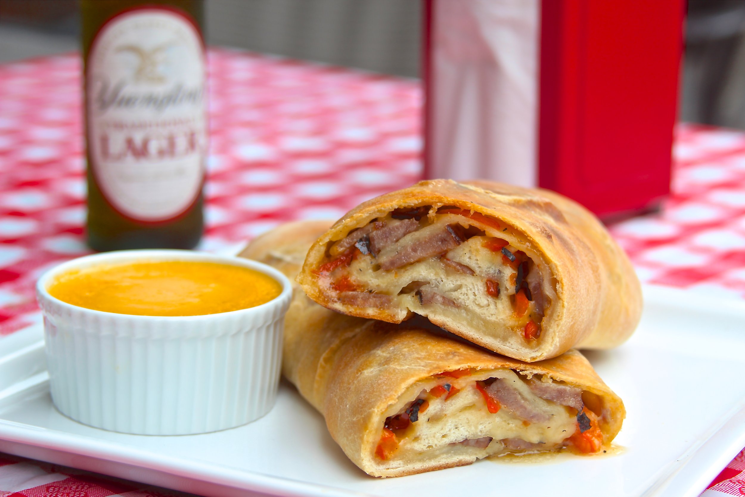 Bratwurst and Charred Pepper Stromboli with Yuengling Lager Cheese Sauce