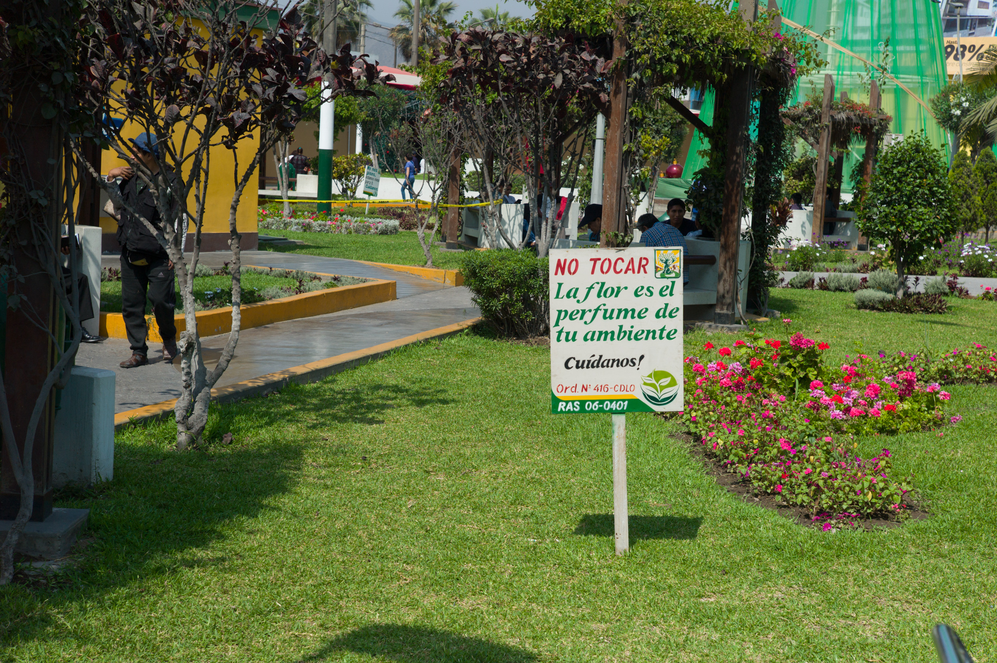  Main district plaza, adjacent to Los Olivos's municipality. Sign reads "do not touch, flowers are the perfume of your environment. Take care of us." 