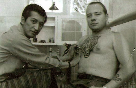 "Lefty Al" Miller with "Tiger Bob" Martinson both tattooers at Tahiti Felix's. Lefty Al was once coined "The youngest tattooer in the world" growing up in Honolulu as a child and has worked at Master Tattoo from 1952-2000. Lefty passed away a few years after.