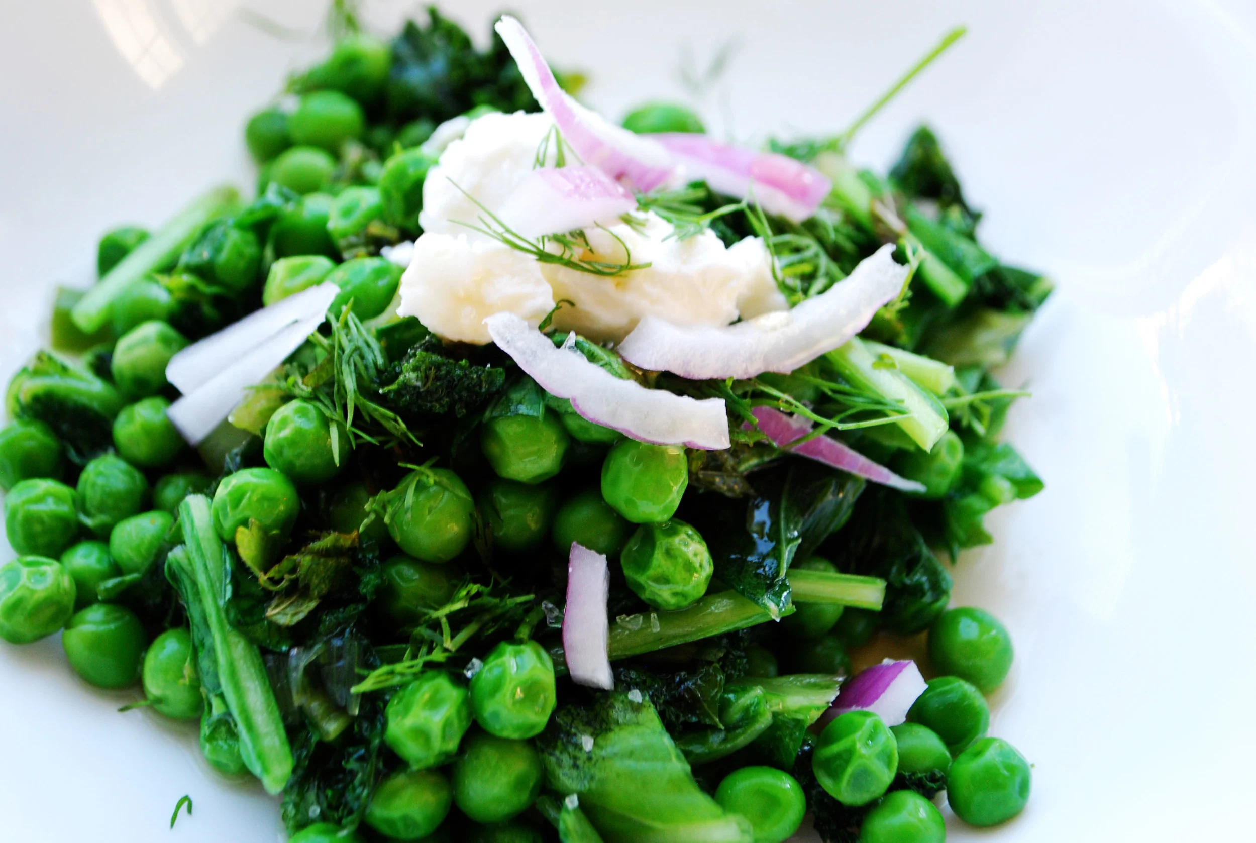   DANDELION GREENS SPRING PEA SALAD      AUTHOR: DESIGN&amp;DIGEST  RECIPE TYPE: SIDE, SALAD  SERVES: 4     INGREDIENTS:  - 1 BUNCH DANDELION GREENS, CHOPPED  - 1 CUP KALE, CHOPPED  - 1 BAG OF FROZEN PEAS, OR FRESH PEAS (SOMETIMES FOUND AT TRADER JOE