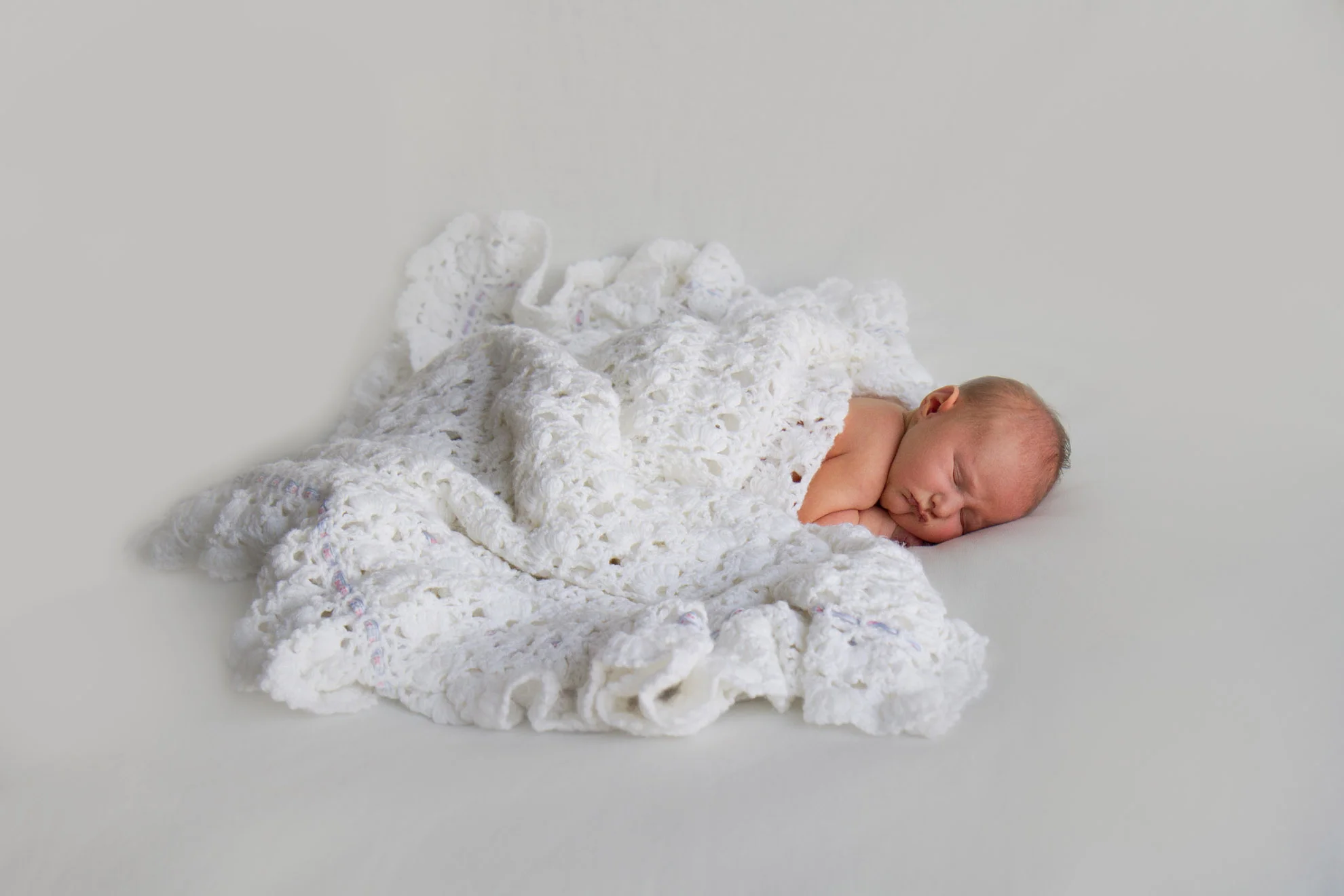 Newborn-photo-with-family-shawl.jpg