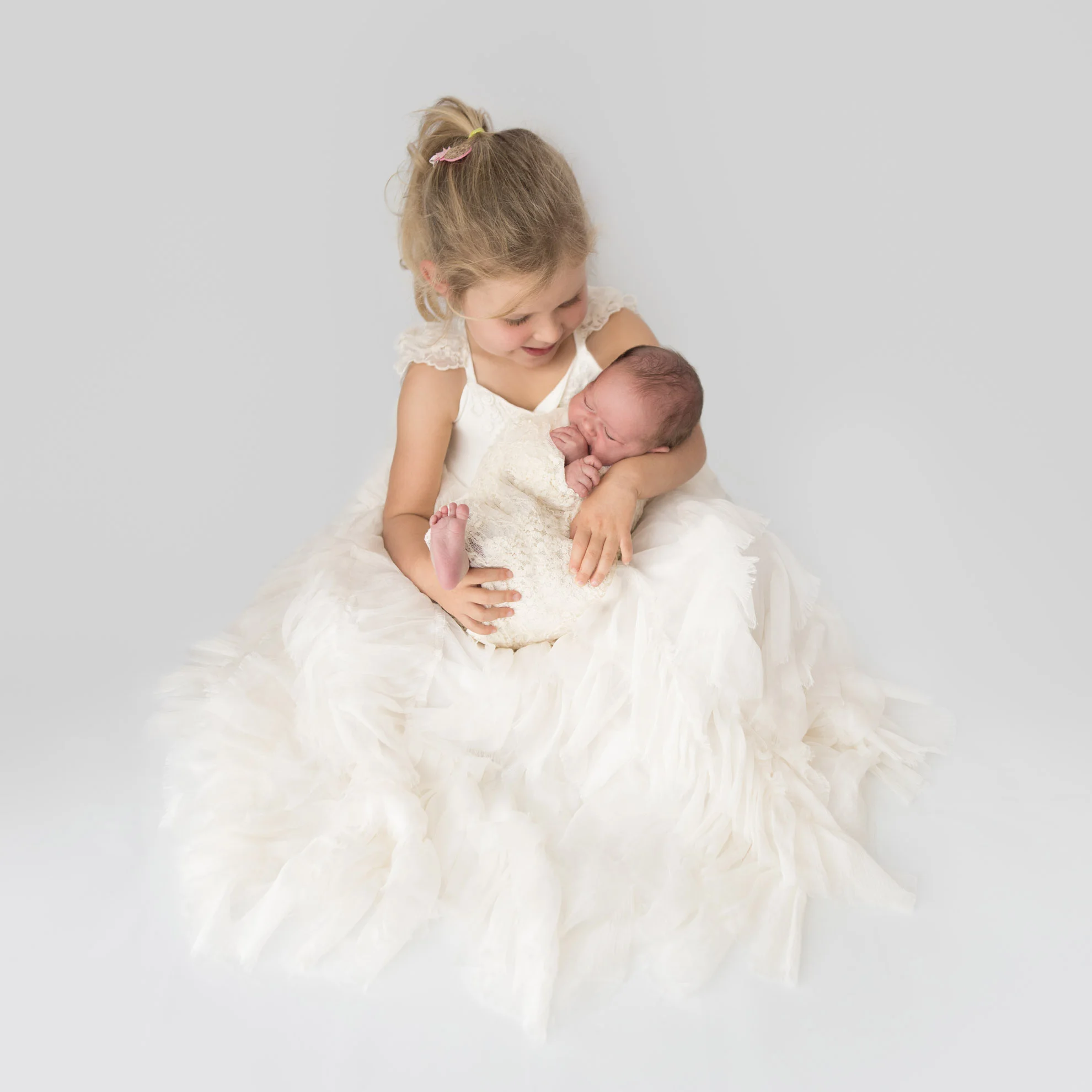 A princess dress, lace wrap, and two gorgeous sister