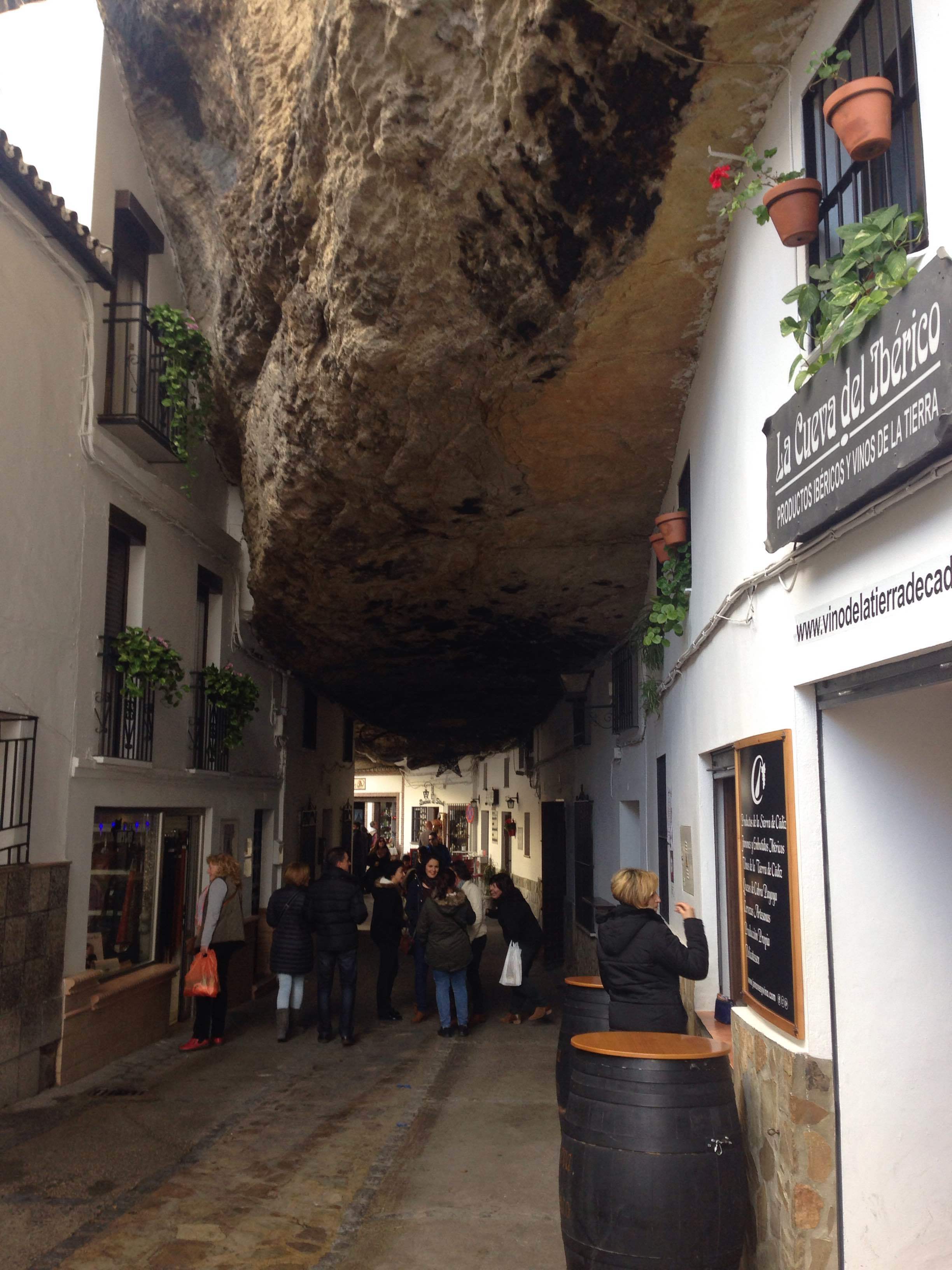 The Sombra, or shadowed side of Setenil, with a street that runs under the rock 